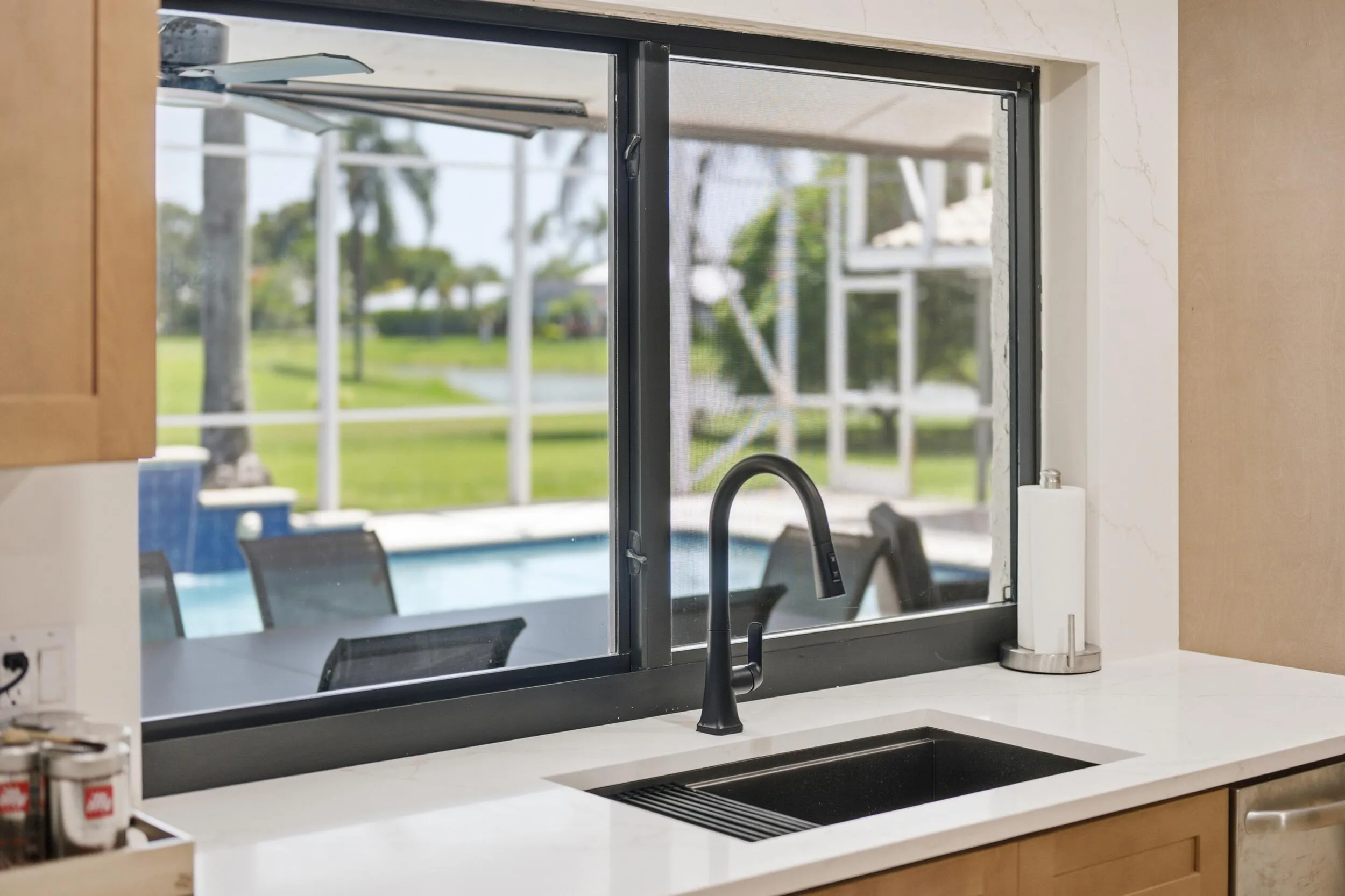 Sink overlooking pool and golf course