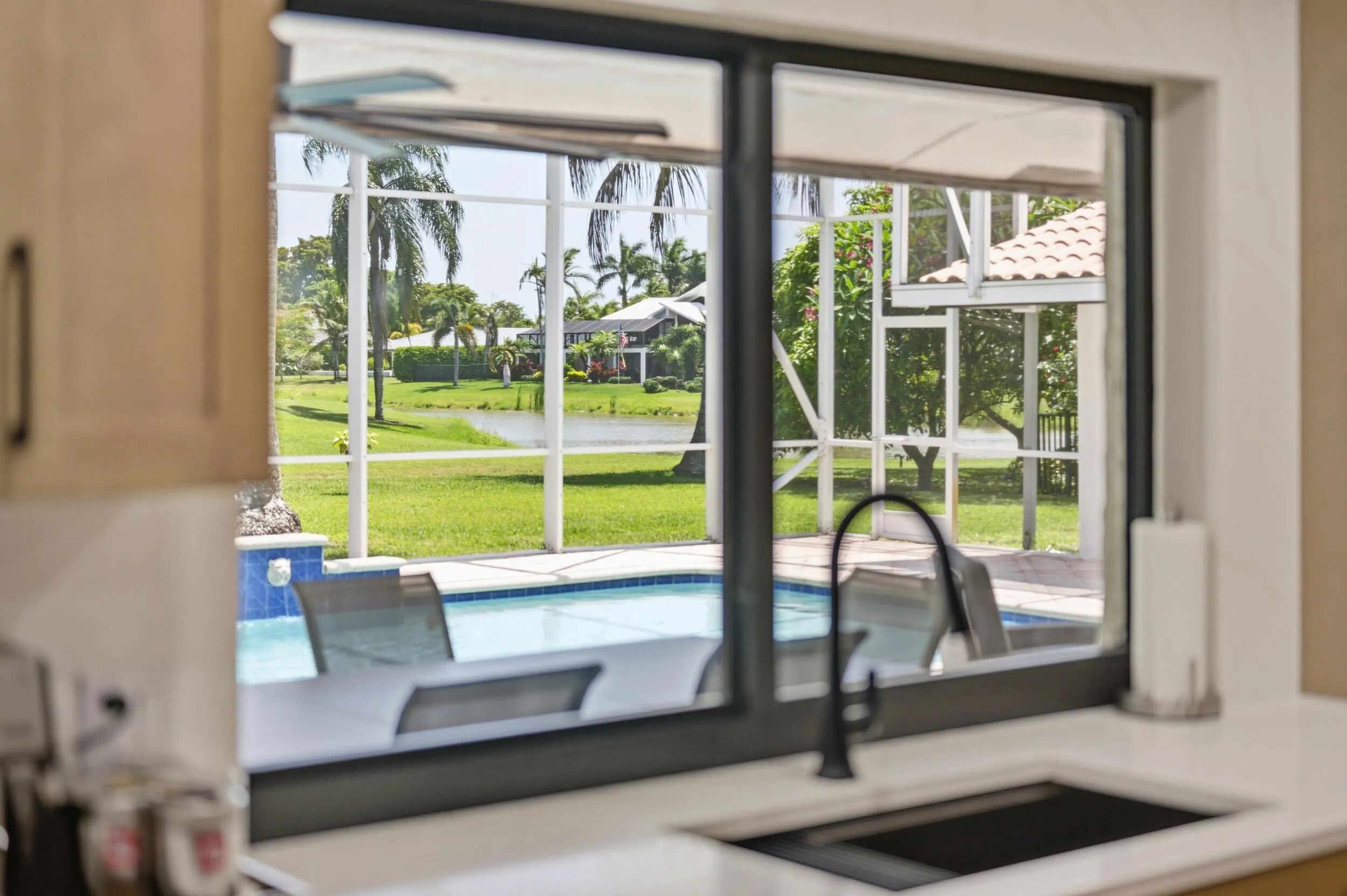 Sink overlooking pool and golf course