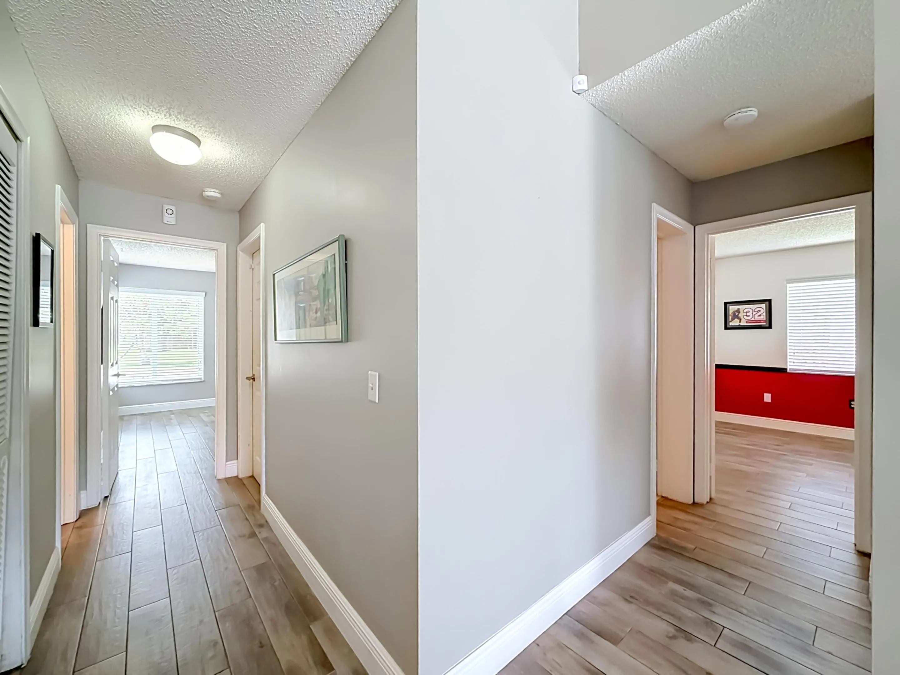 Hallway to 3rd split, 4th bedroom with full bath on left