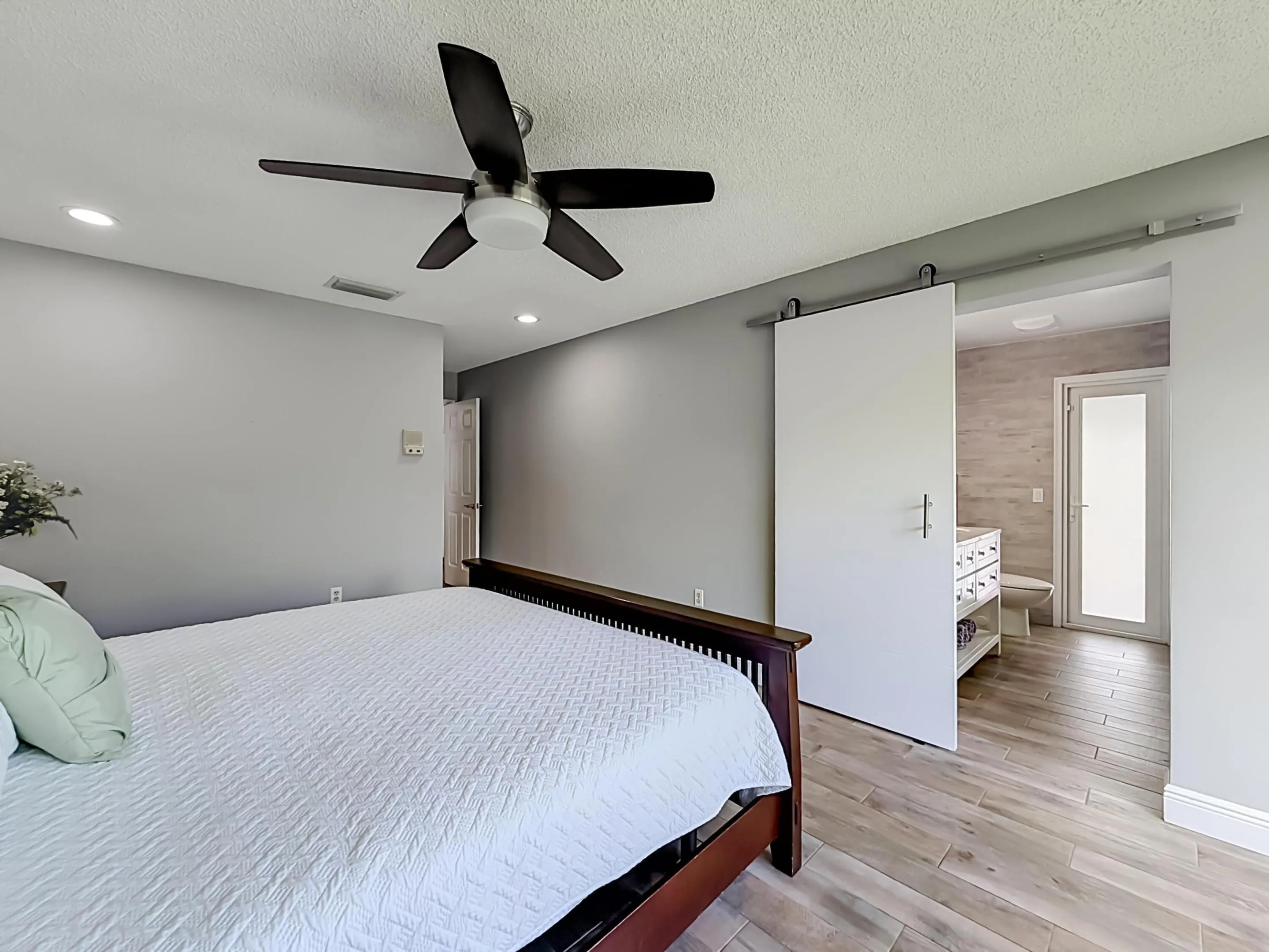 Primary with sliding door to remodeled bathroom