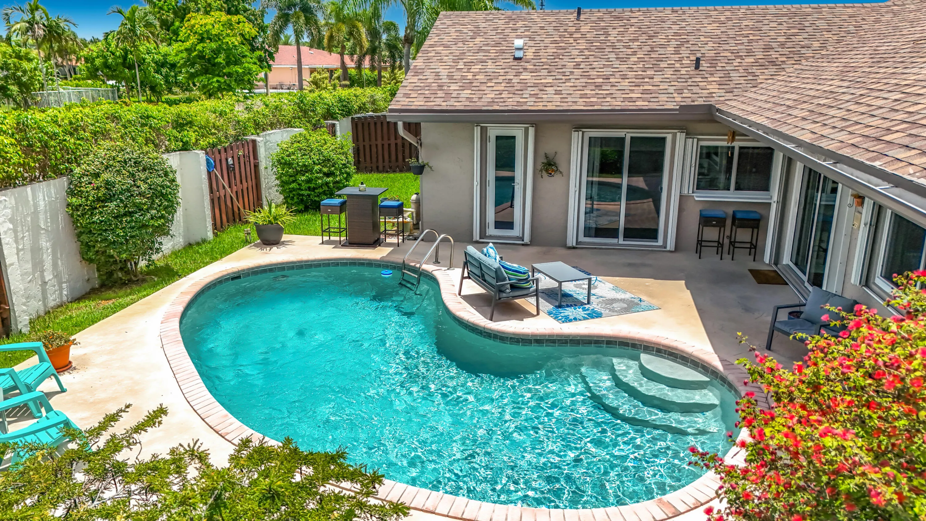 Aeriel of pool area and home with shutters and all impact