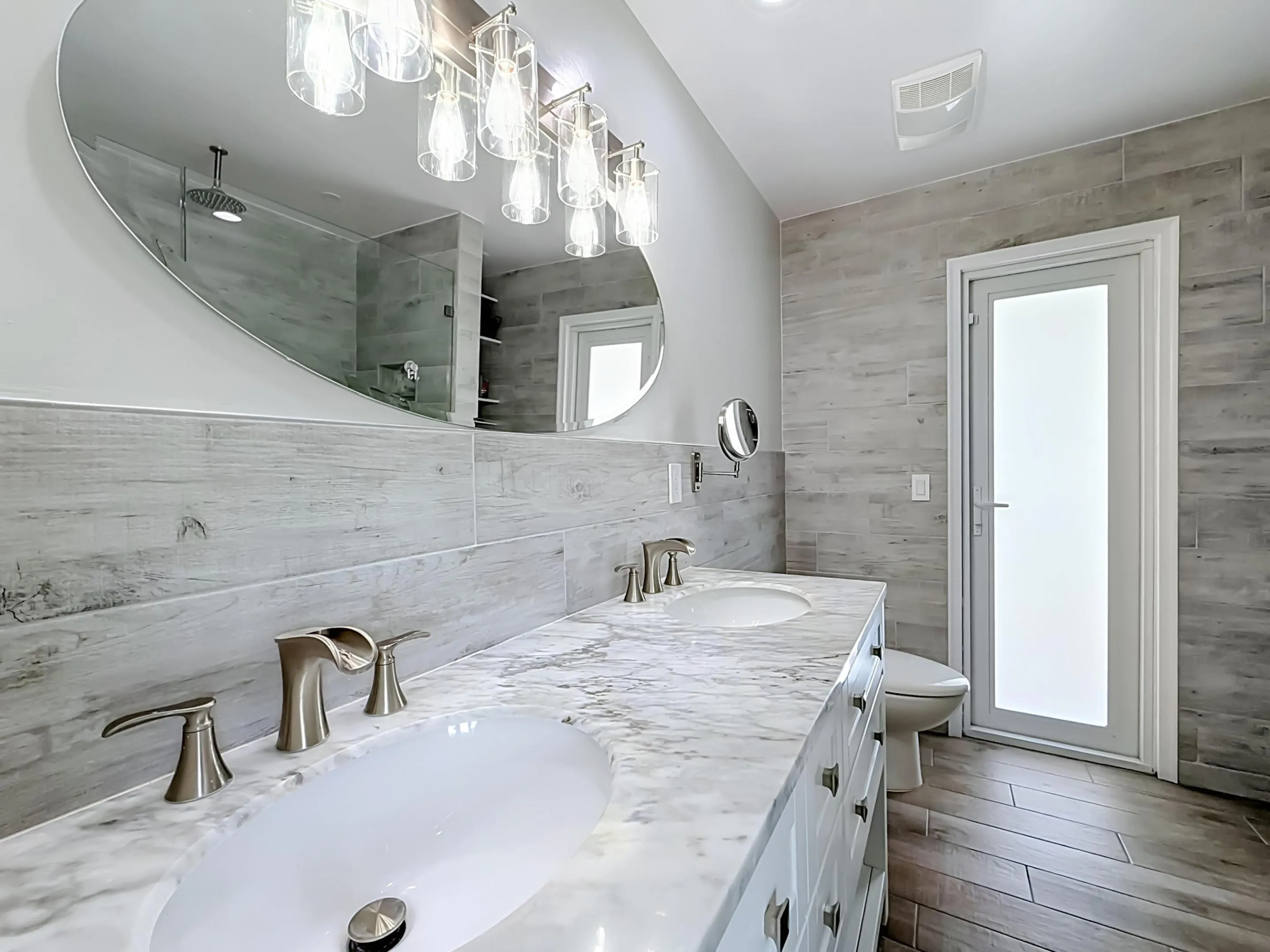 Primary bathroom with dual sinks out to pool