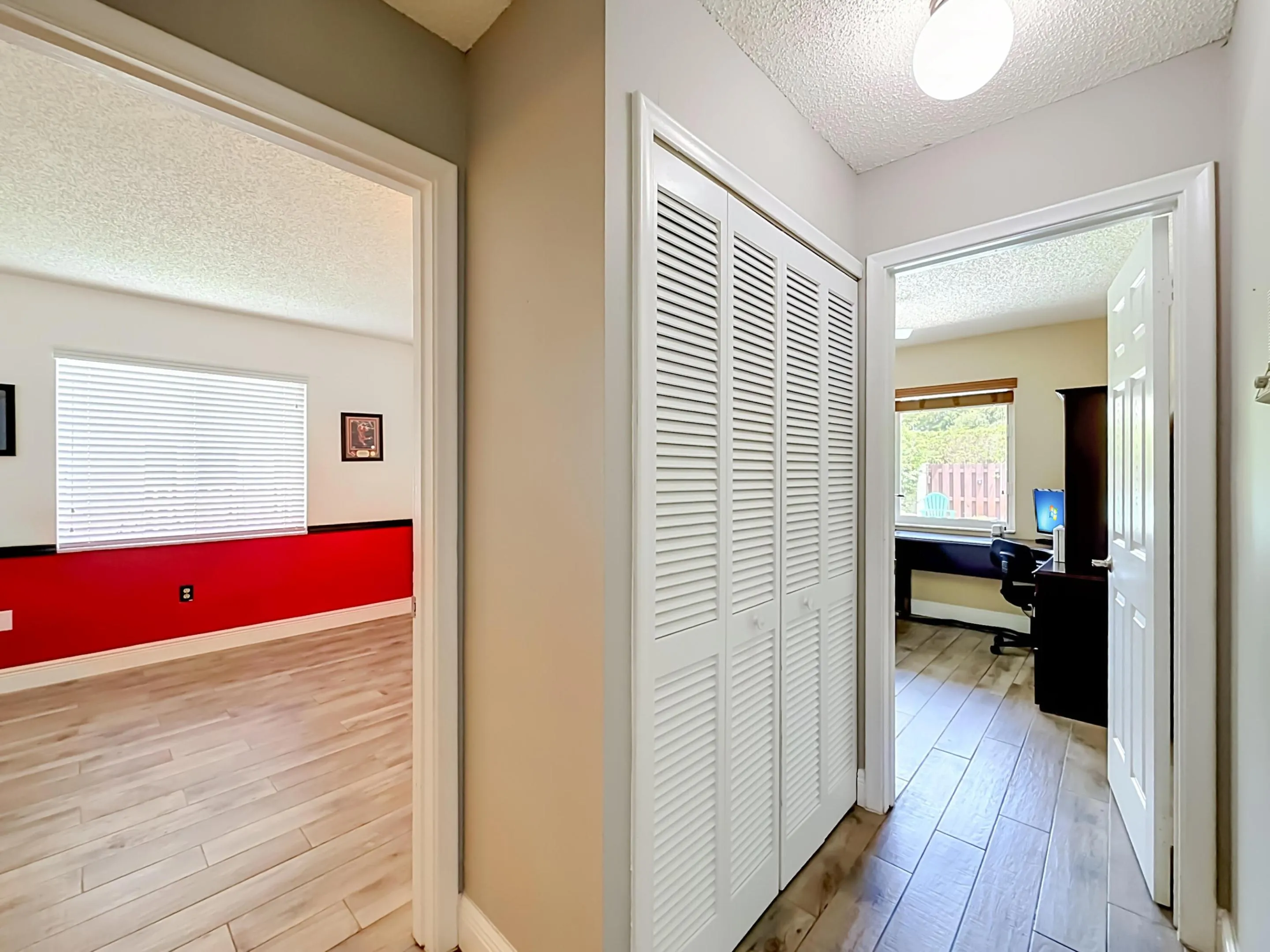 Hallway to 2nd split, View of bedroom 3 Heat decor and 2nd office decor with view of pool area