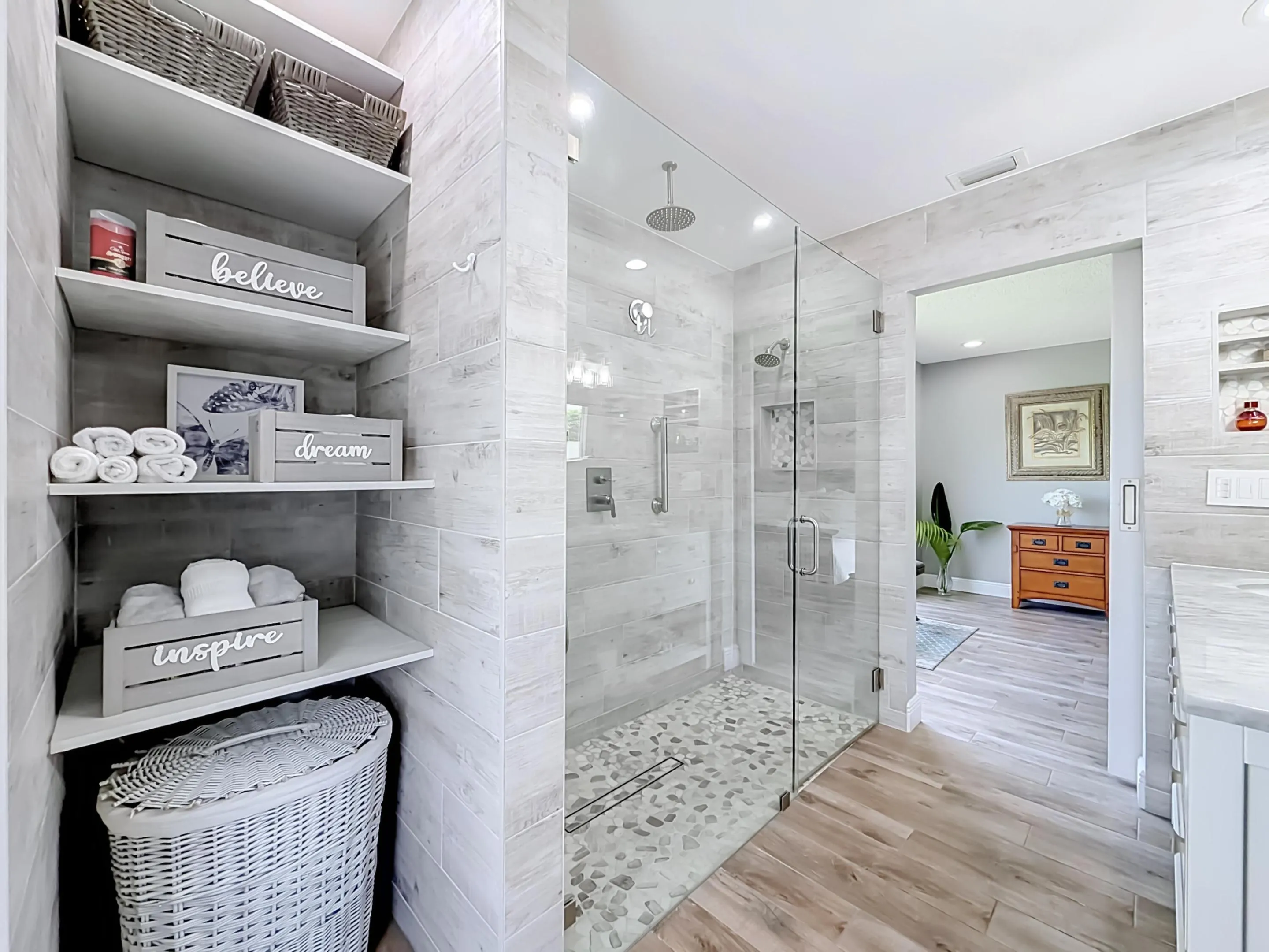 Primary shelving with shower view of bedroom