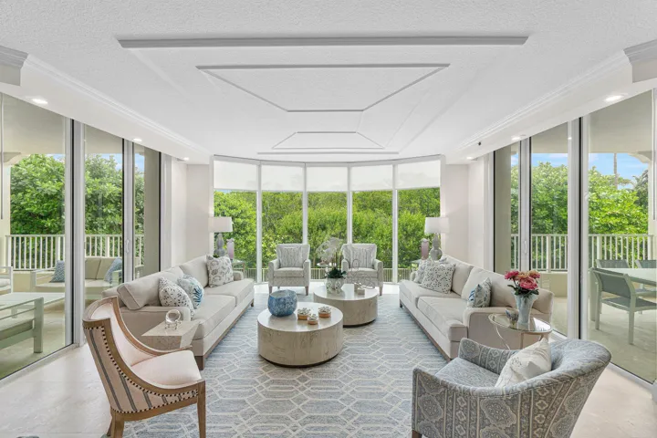 WALLS OF IMPACT GLASS AND VIEWS OF LUSHLY LANDSCAPED GROUNDS
