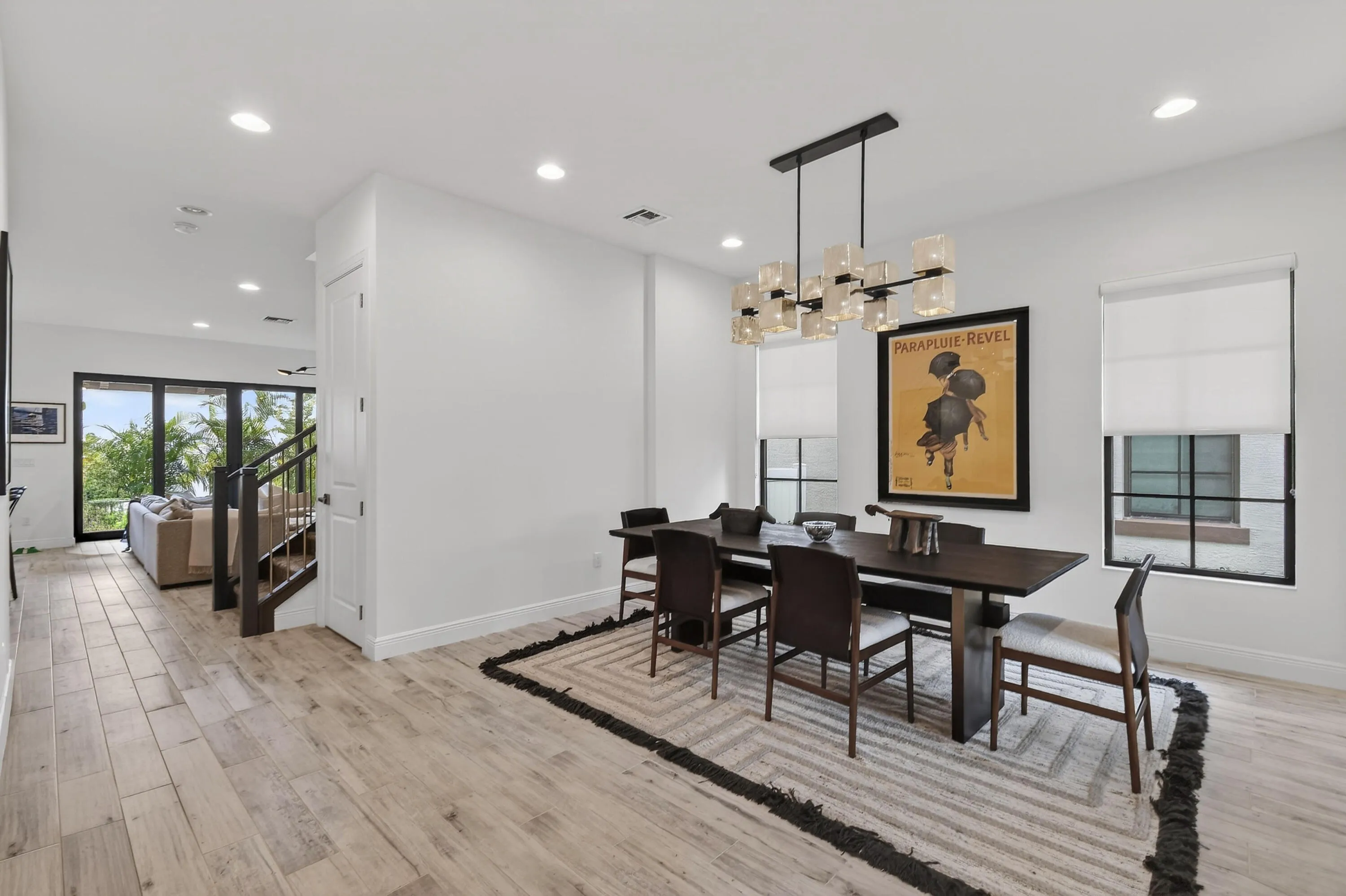 Elegant dining room with expansive windows and natural sunlight throughout.