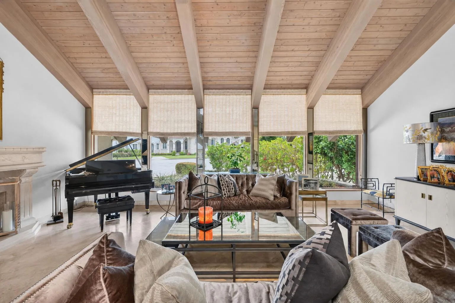 The living room centers around a fireplace and piano lounge.