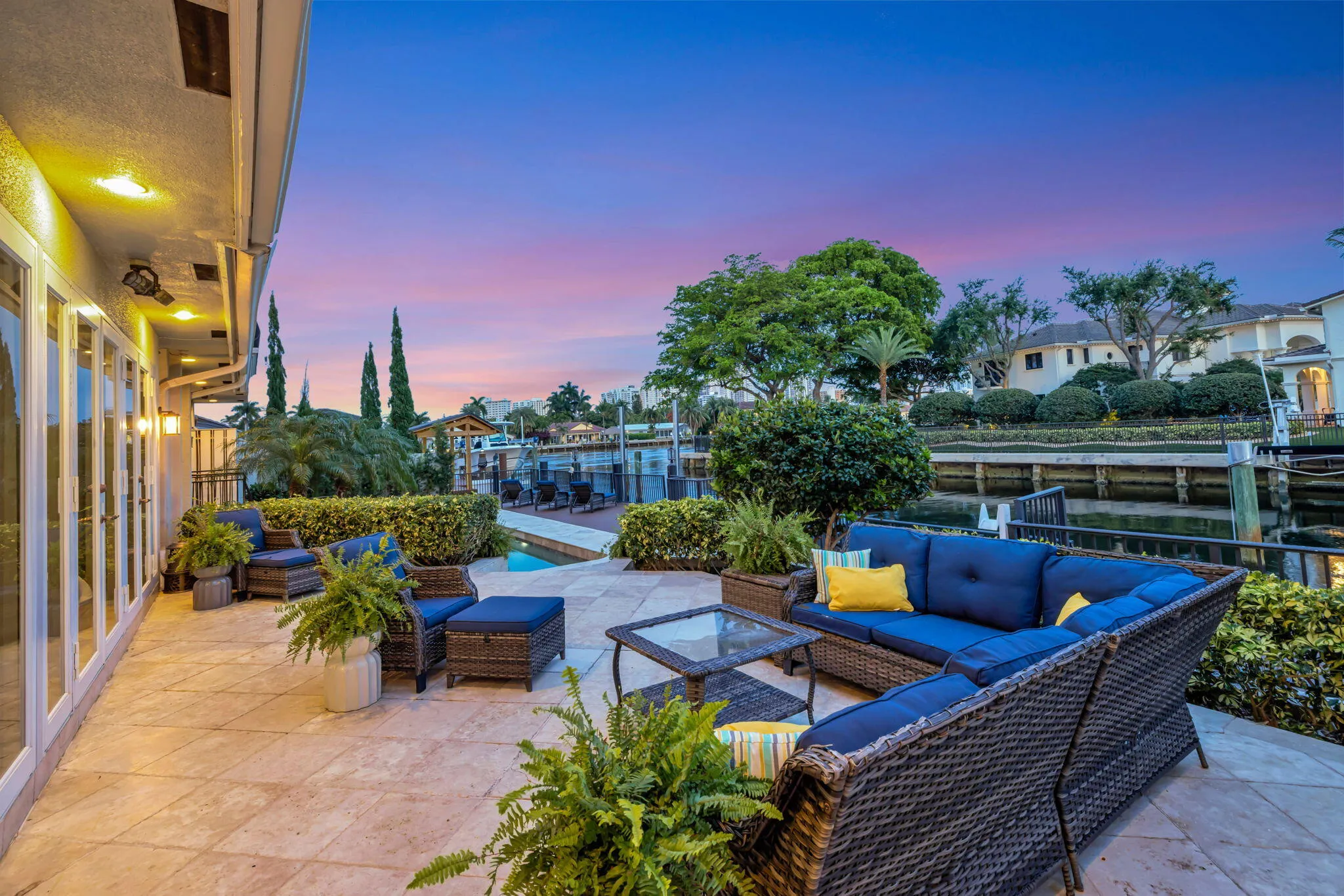 At twilight, the waterfront patio becomes an inviting outdoor entertaining space with dramatic evening color.