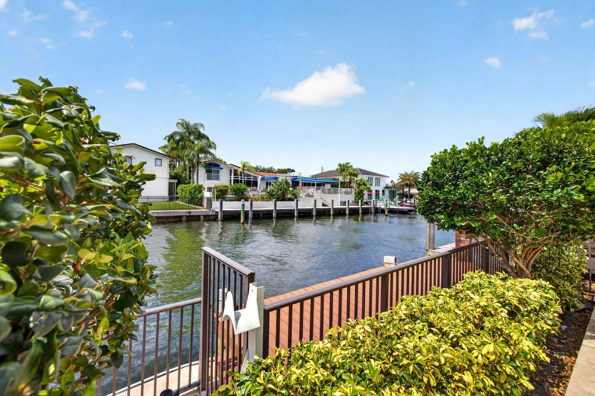 The terrace frames peaceful water views, emphasizing the home’s Fort Lauderdale waterfront setting.
