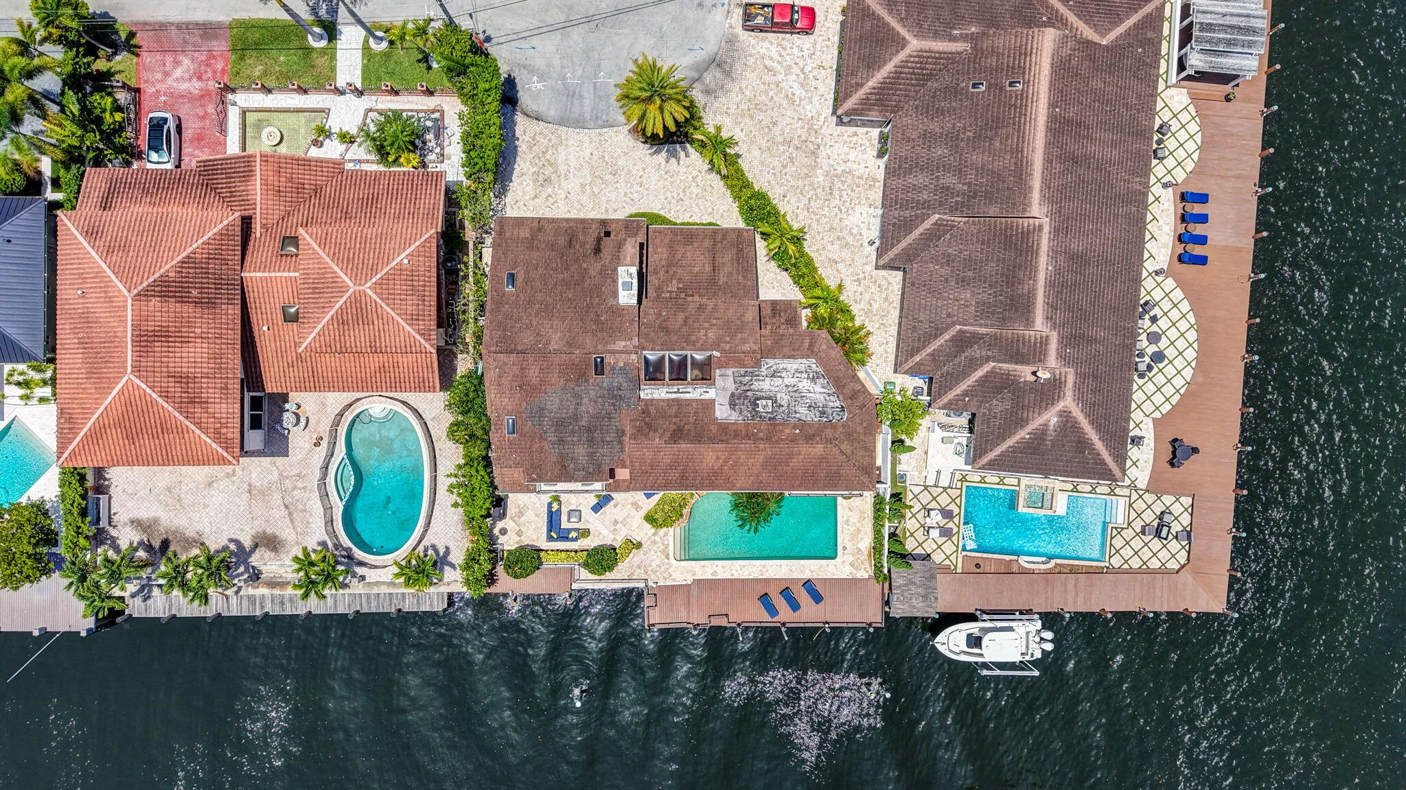 The overhead aerial clarifies the lot layout, pool placement, dockage, and waterfront orientation.