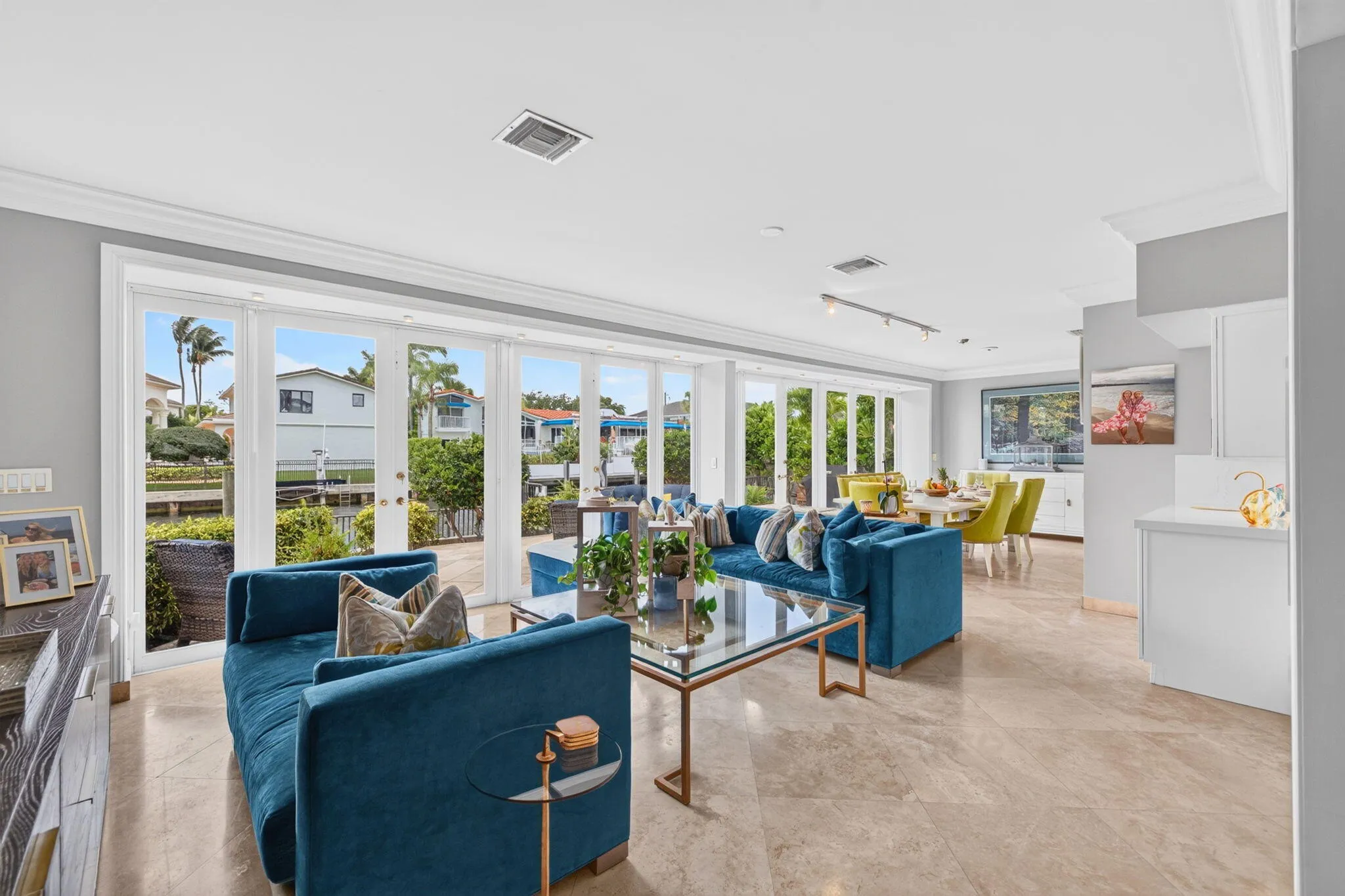 The waterfront family room is bright and relaxed, with wide windows drawing attention to the outdoor setting.