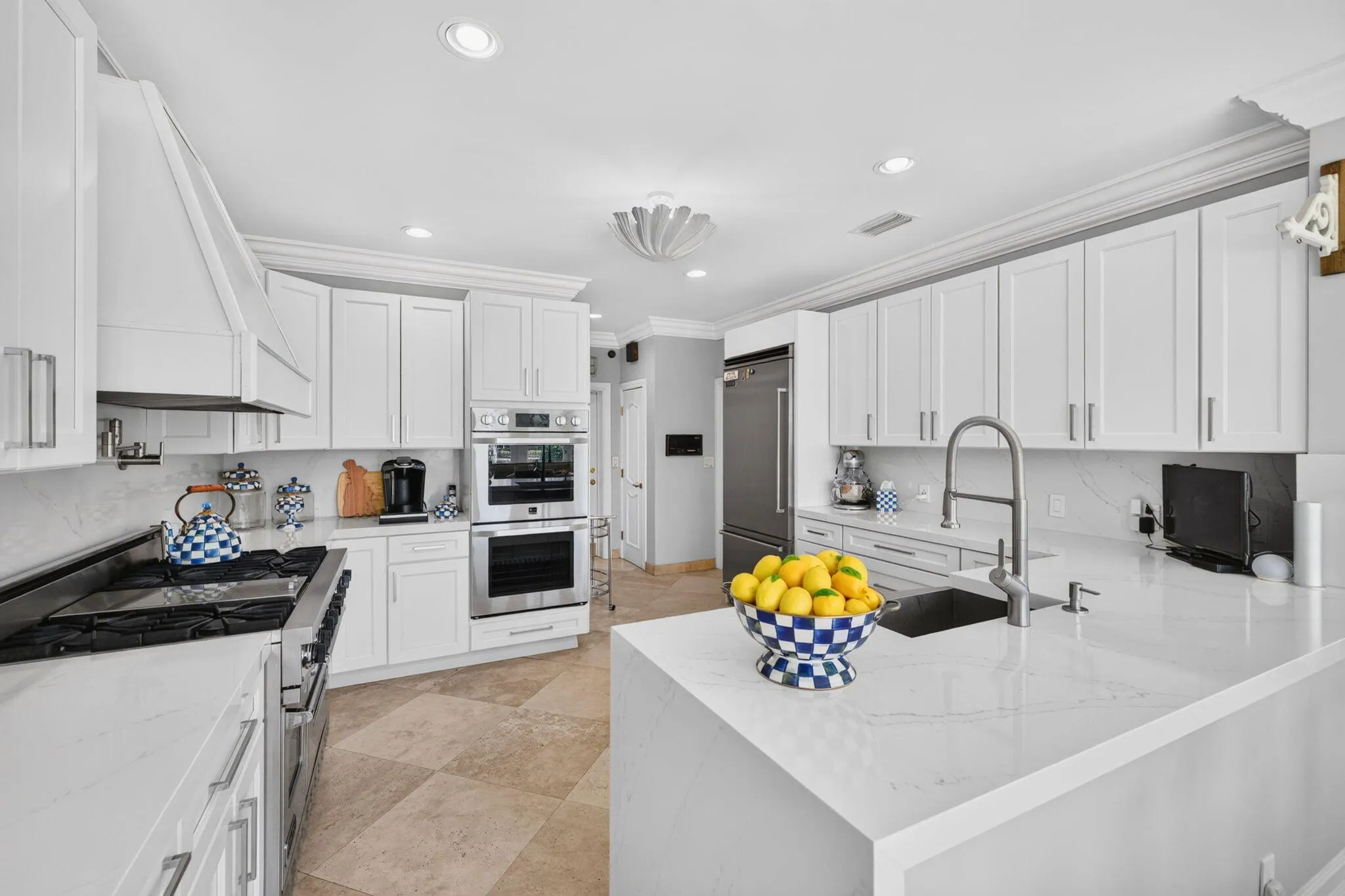 A central island anchors the kitchen with generous prep space, clean finishes, and strong functionality.