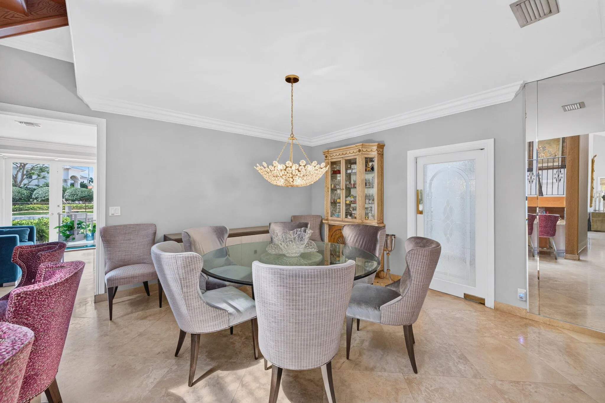 The dining room offers a polished setting with soft natural light and garden-facing views.
