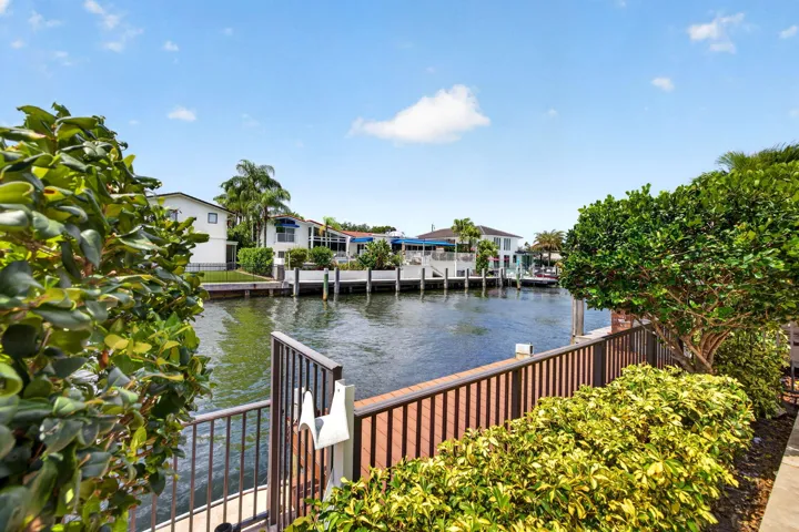 The terrace frames peaceful water views, emphasizing the home’s Fort Lauderdale waterfront setting.