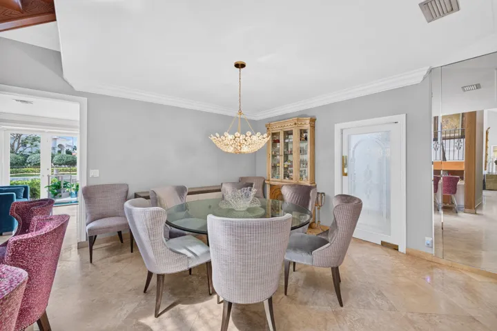 The dining room offers a polished setting with soft natural light and garden-facing views.