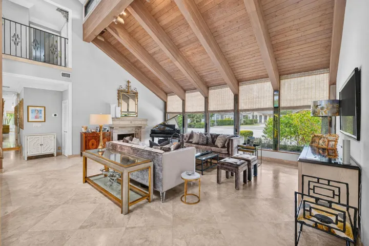 The living room centers around a fireplace and piano lounge.