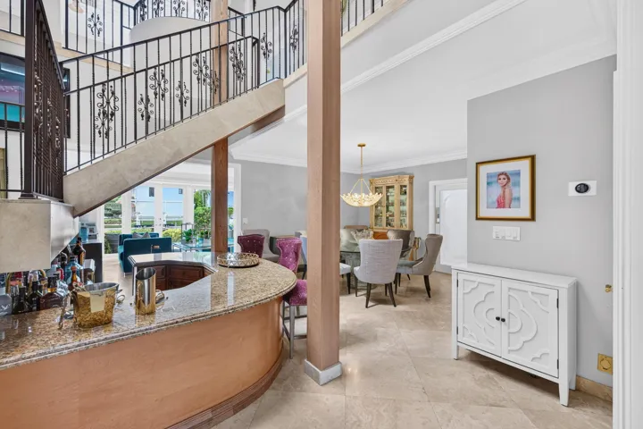 A convenient wet bar connects the entertaining spaces and supports effortless hosting between the living and dining areas.