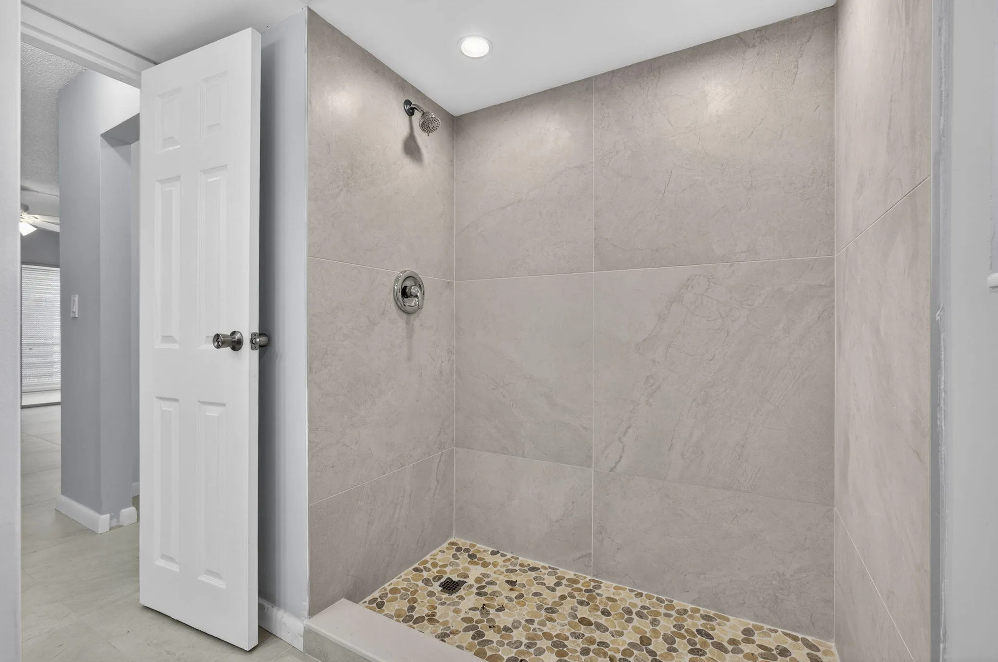 View of walk-in shower of master bathroom with tile from top to bottom