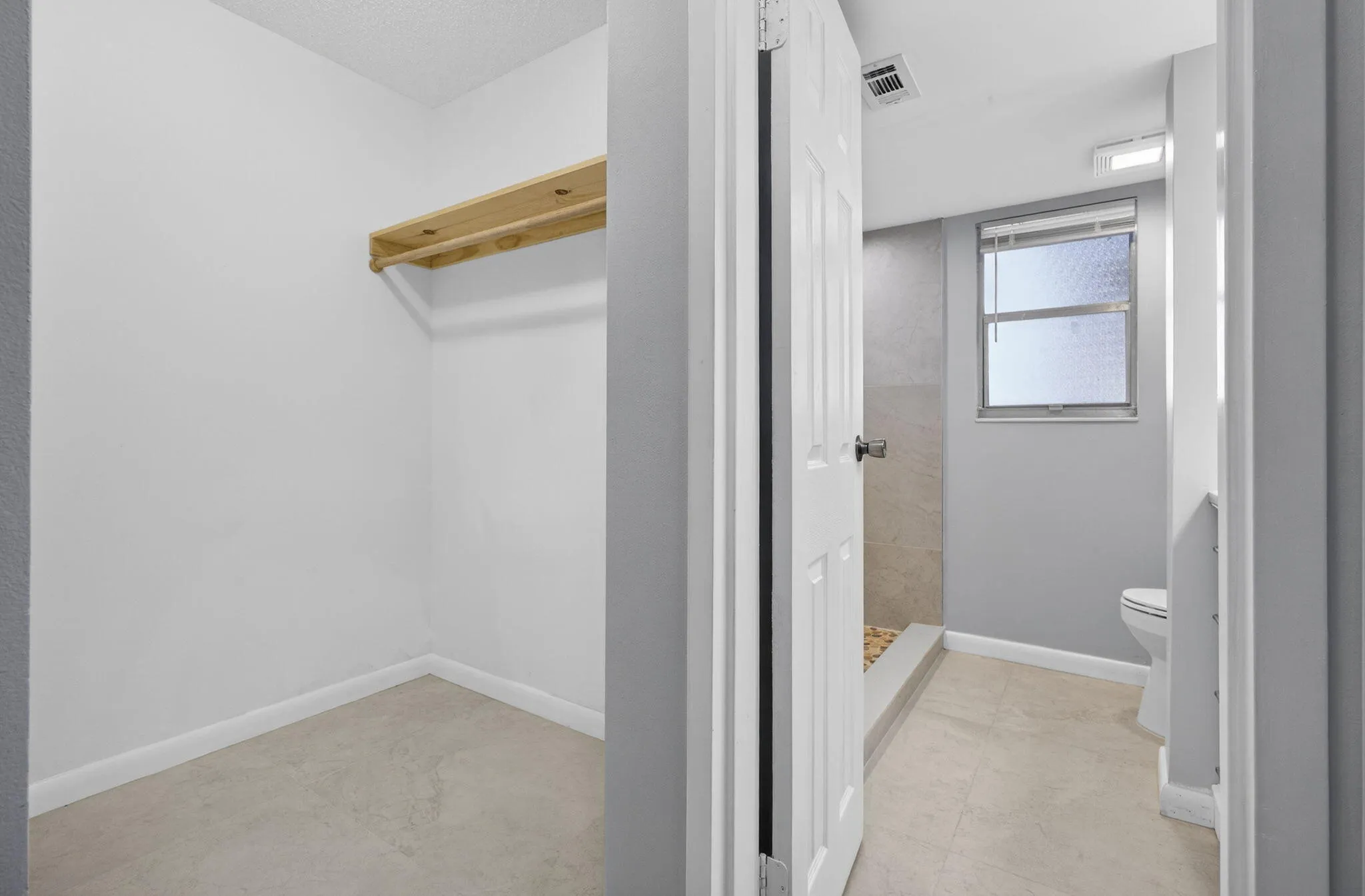 View of master walk-in closet and master bathroom