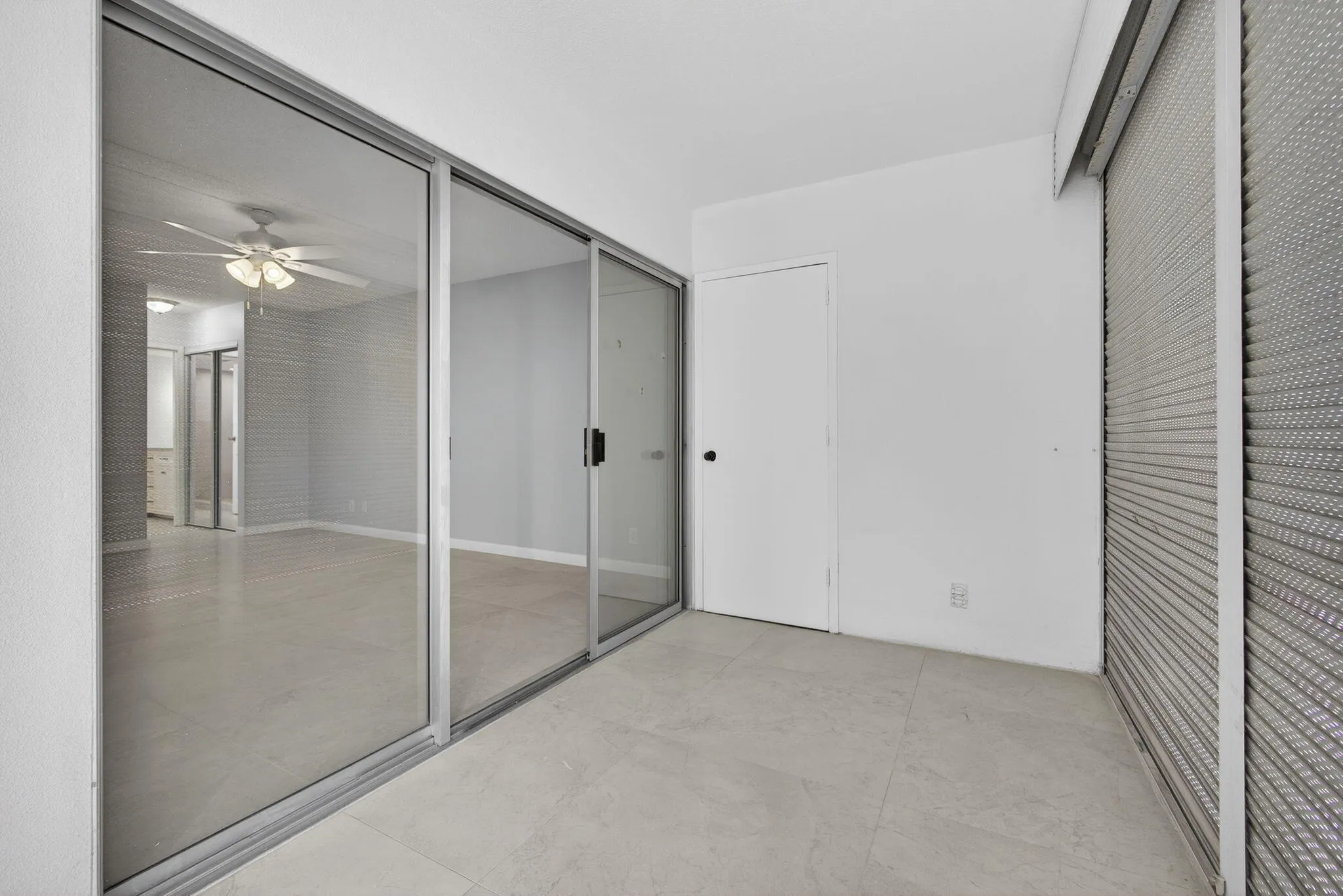 View of master bedroom from balcony showing storage closet