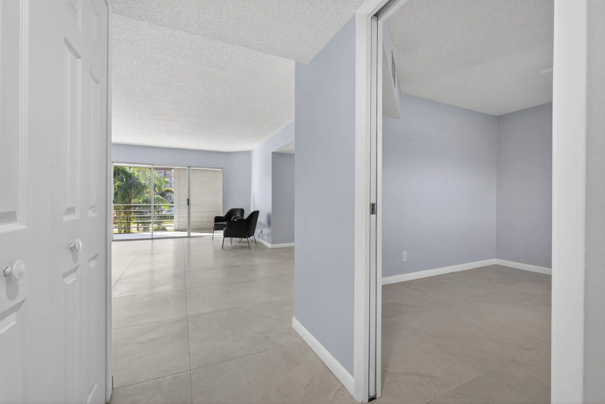 View of guest bedroom and living area from entry door