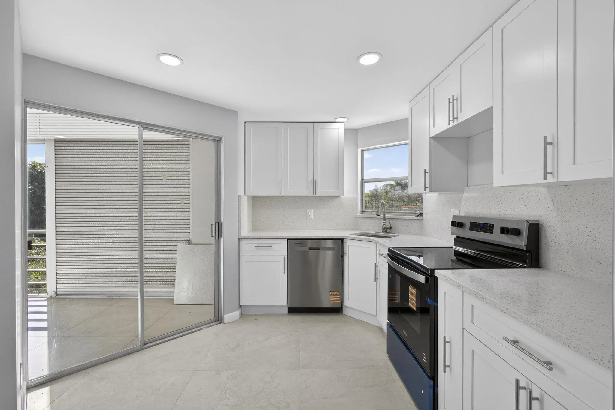 View of kitchen with white shaker soft closing cabinets, new appliances, Italian tiles, electrical panel