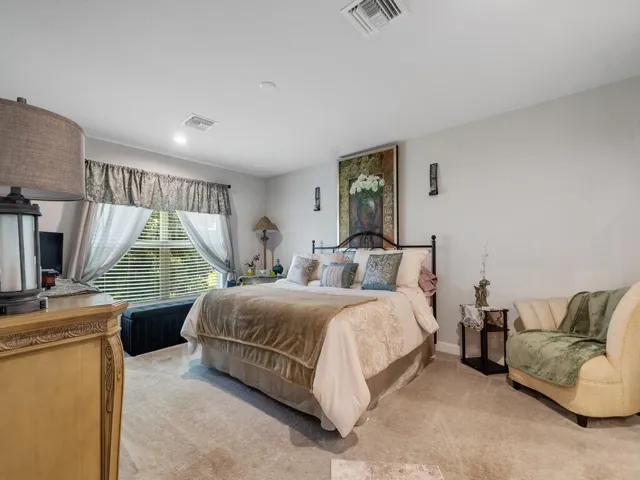 Spacious room featuring light gray walls and plush carpeting