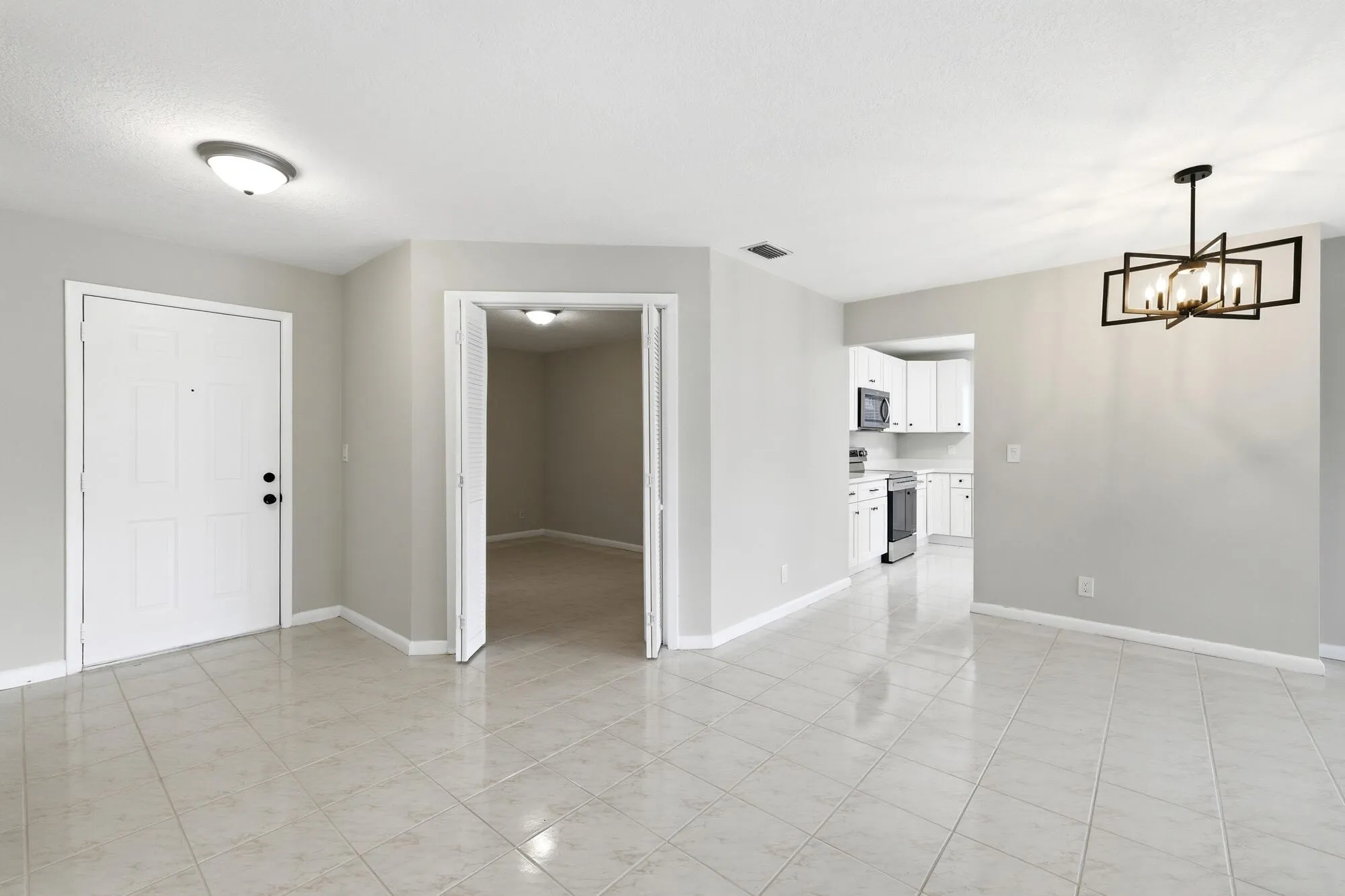 View of entry way and 1st bedroom off the main living space