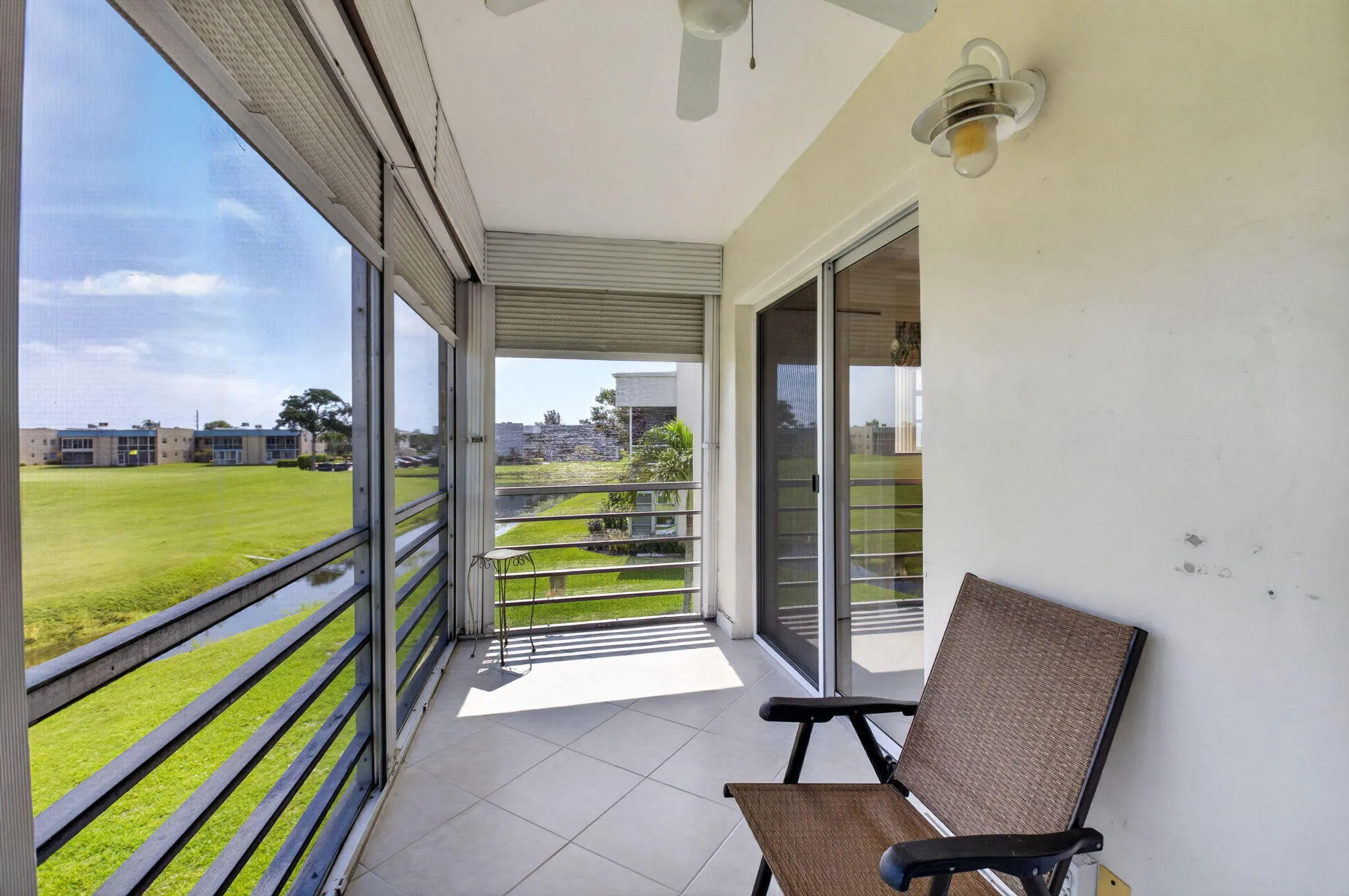 Step outside to a screened balcony with peaceful lake and golf views!