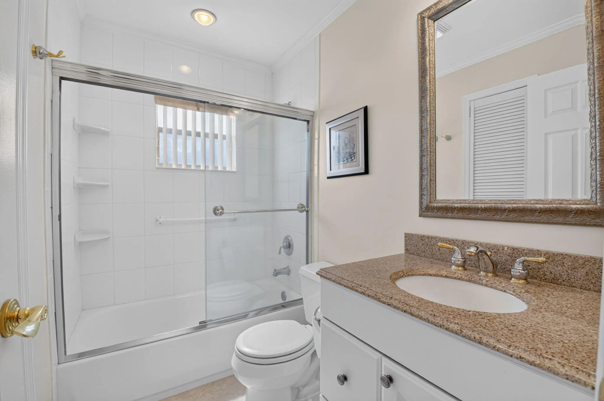 Primary bathroom with an added, custom LINEN closet! A rare find in Kings Point!