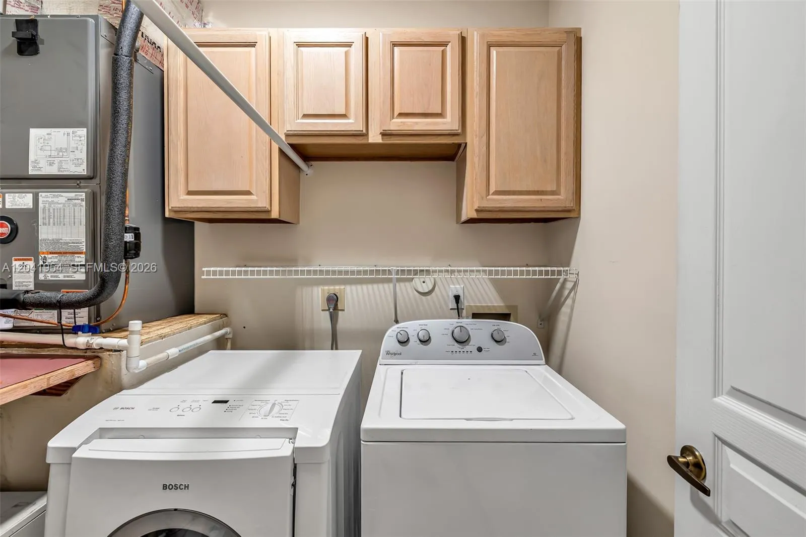 LAUNDRY ROOM OFFERS EXTRA STORAGE