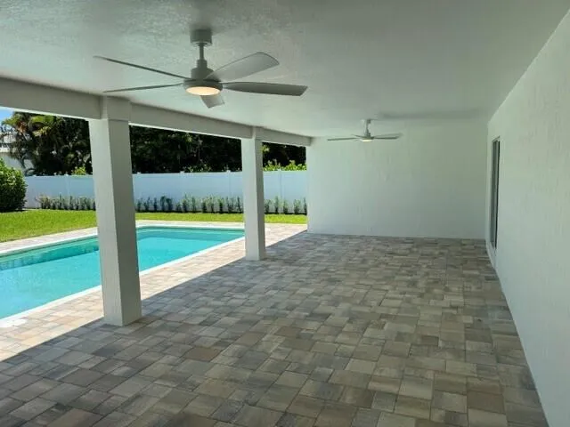 Beautiful, covered Lanai with view of the pool and back yard. Brick pavers installed 2026 on Lanai and around pool.