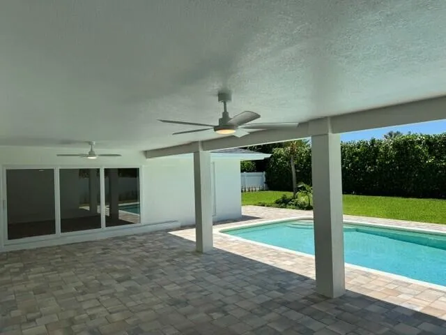Covered Lanai with view of the pool and back yard. Brick pavers installed 2026 on Lanai and around pool.