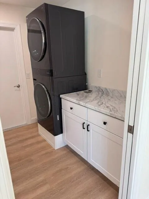 Utility room with washer and dryer installed 2025, cabinets installed 2026 with flooring and fresh paint.