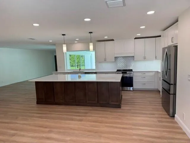 Kitchen cabinets, countertops, and large island installed 2026