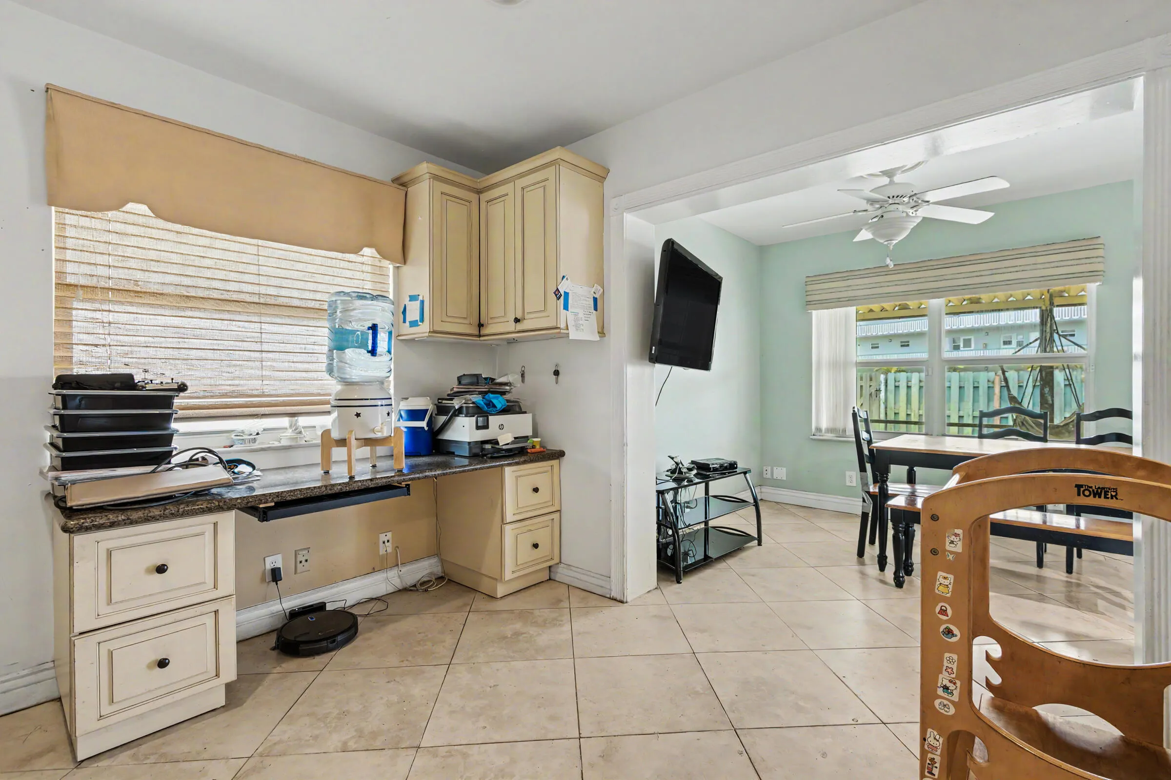built in desk or office area off the kitchen with matching cabinetry and countertops