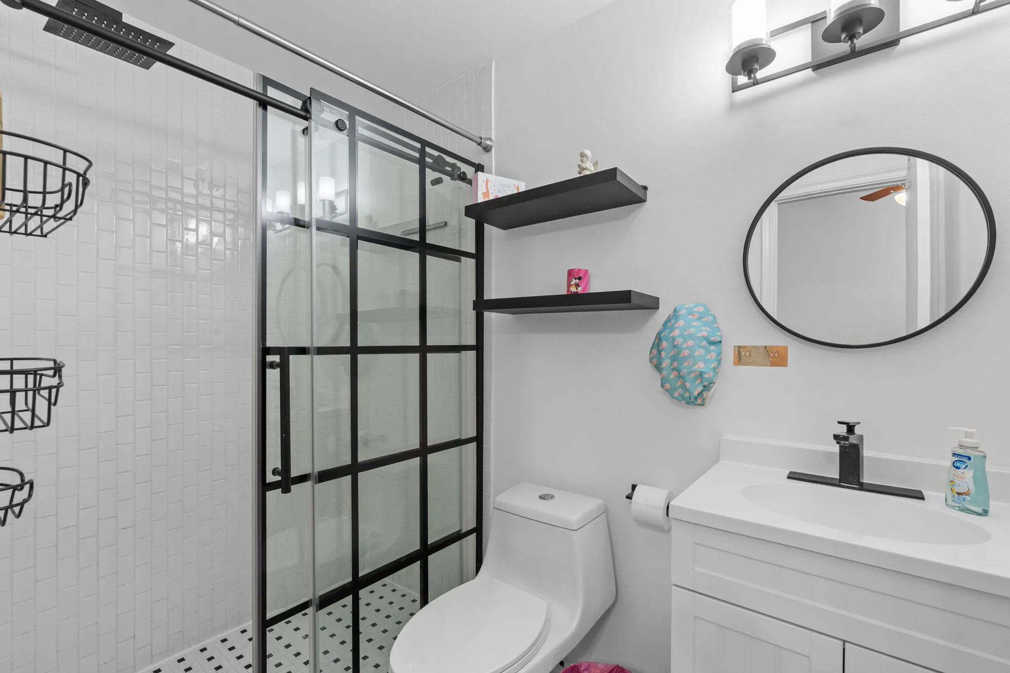 MODERN SHOWER WITH GLASS SLIDING DOORS IN SECOND BEDROOM