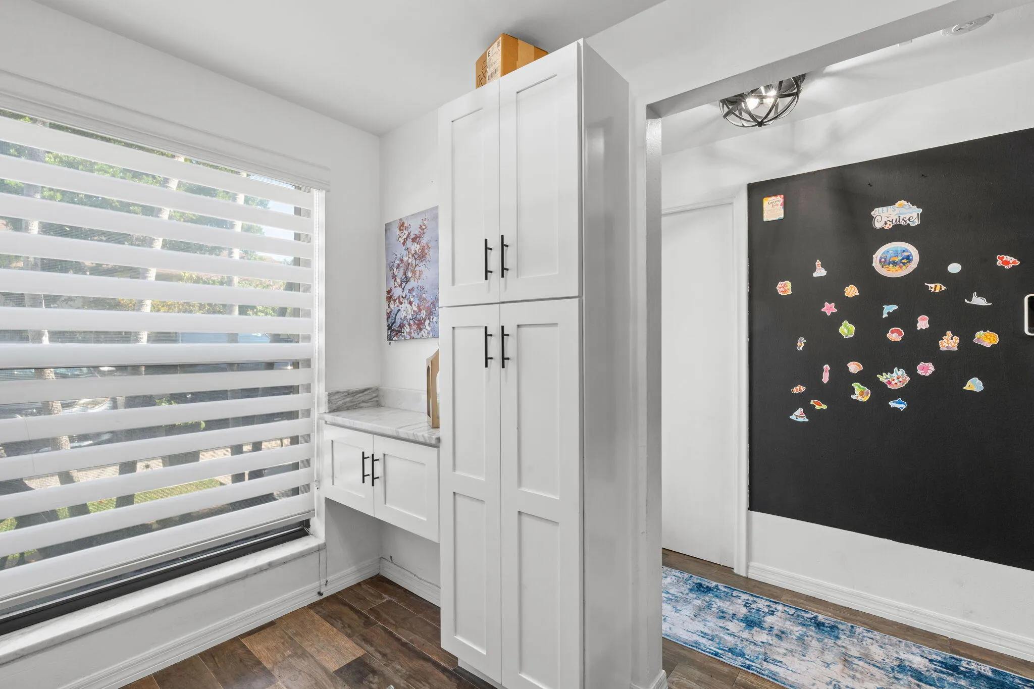 PANTRY AND DESK WITH ZEBRA WINDOW TREATMENTS