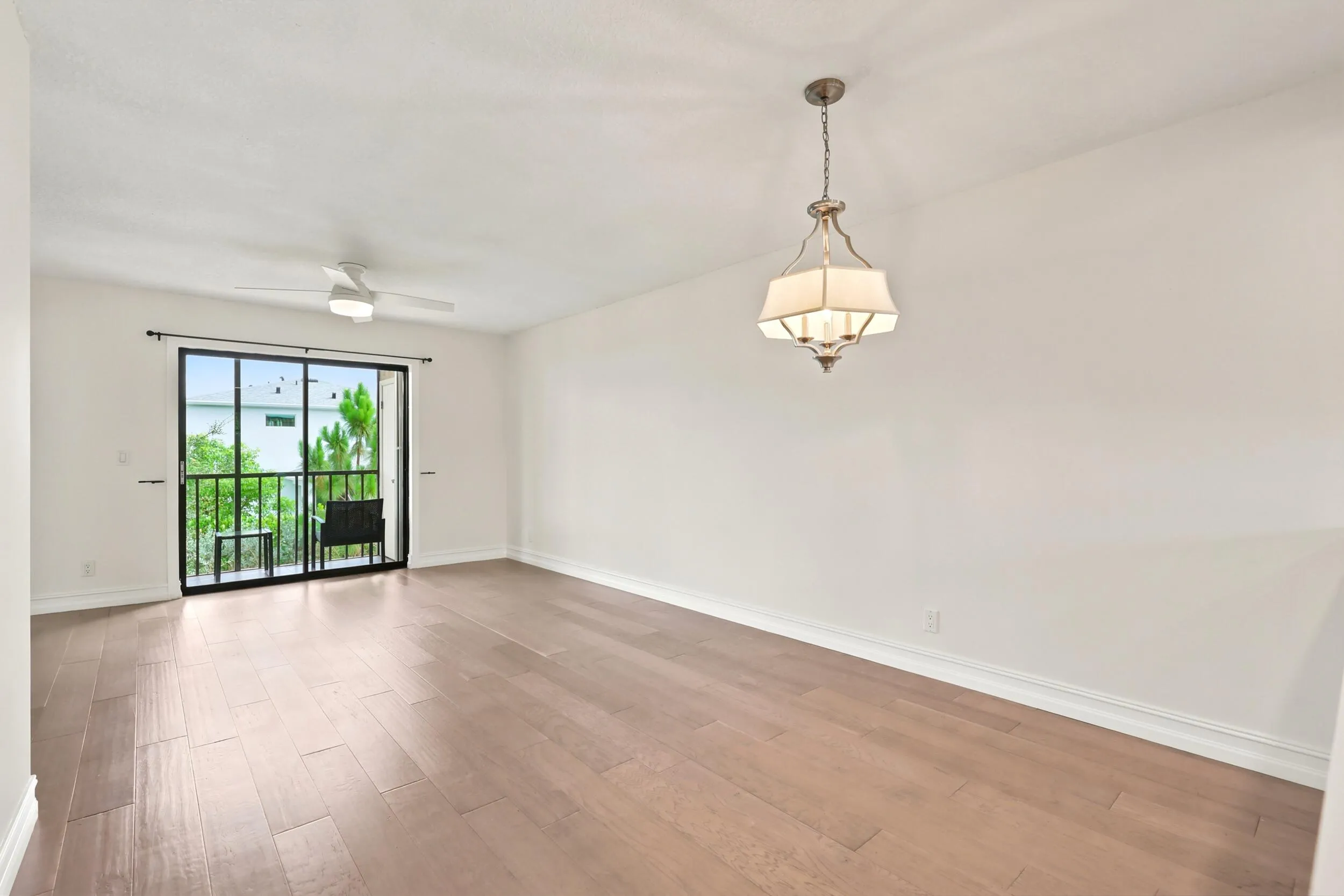The spacious living area offers an open and versatile layout designed for comfortable everyday living and entertaining. Updated flooring flows throughout the space, while large sliding glass doors fill the room with natural light and provide seamless access to the private screened balcony. The open-concept design connects effortlessly to the kitchen and dining areas, creating a bright and inviting atmosphere throughout the home.