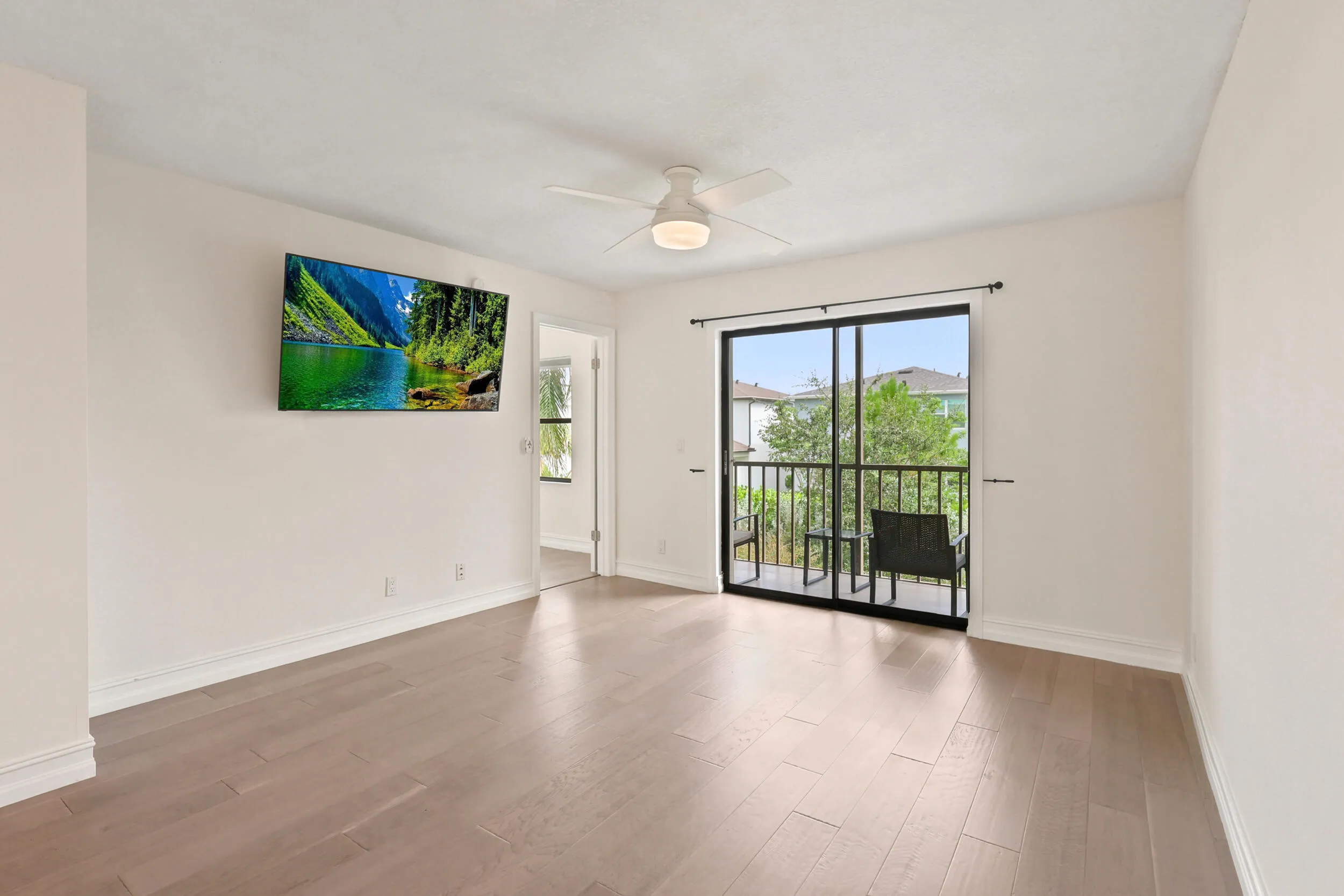 The spacious living area offers an open and versatile layout designed for comfortable everyday living and entertaining. Updated flooring flows throughout the space, while large sliding glass doors fill the room with natural light and provide seamless access to the private screened balcony. The open-concept design connects effortlessly to the kitchen and dining areas, creating a bright and inviting atmosphere throughout the home.