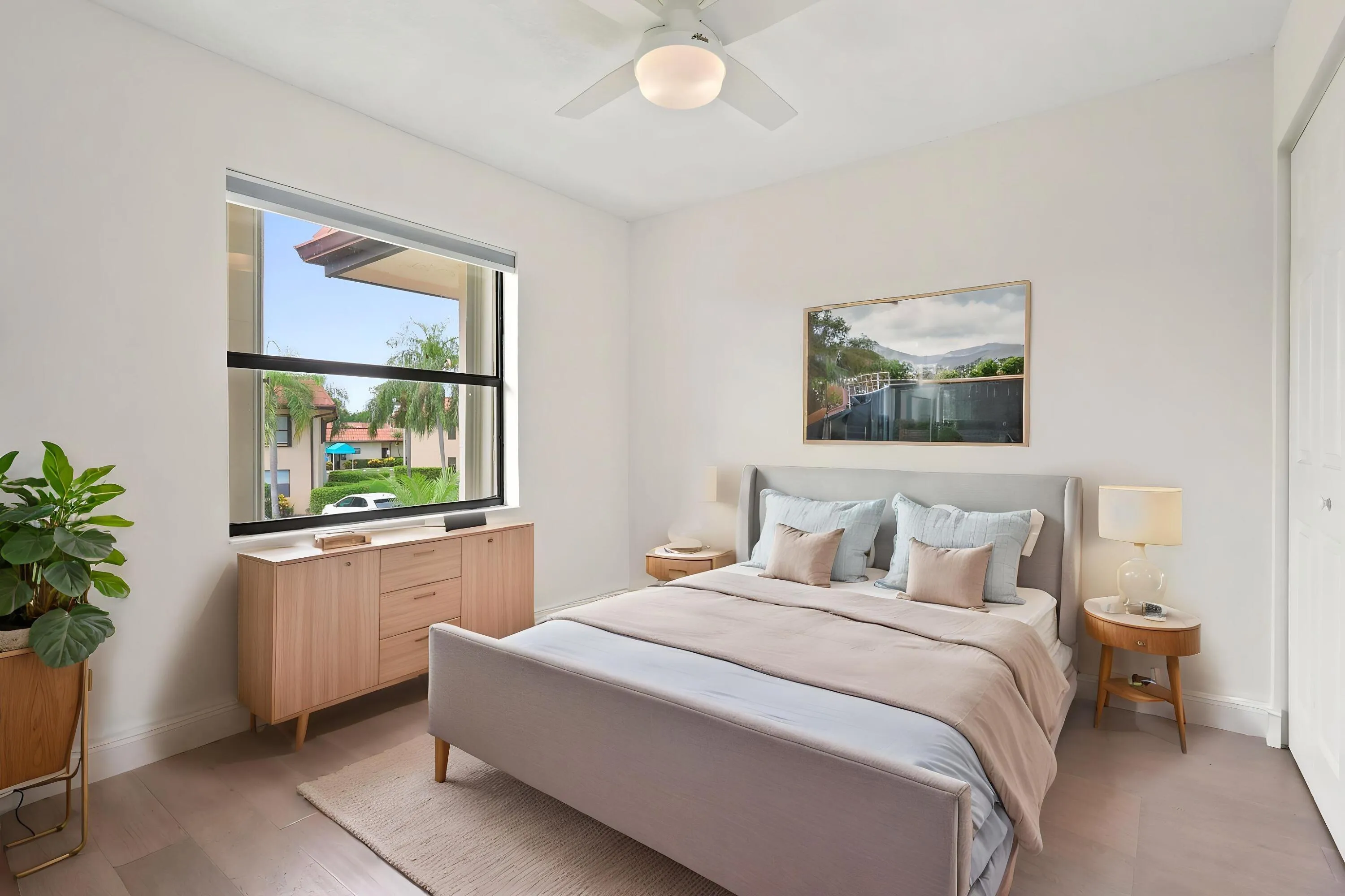 Bright and comfortable, the guest bedroom features updated flooring, generous closet space, and a large window that brings in plenty of natural light while overlooking the community's beautifully maintained grounds. The versatile layout is ideal for guests, a home office, or additional living space, offering both comfort and flexibility.