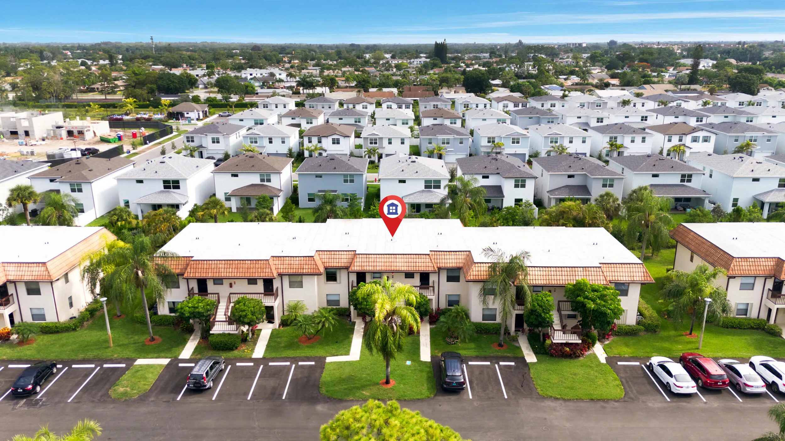 Enjoy a bird’s-eye perspective of this well-maintained community, showcasing the building's convenient location, abundant parking, mature tropical landscaping, and beautifully maintained grounds. Positioned within a peaceful residential setting, the property offers easy access to nearby shopping, dining, golf courses, parks, and major commuter routes while providing a tranquil place to call home.