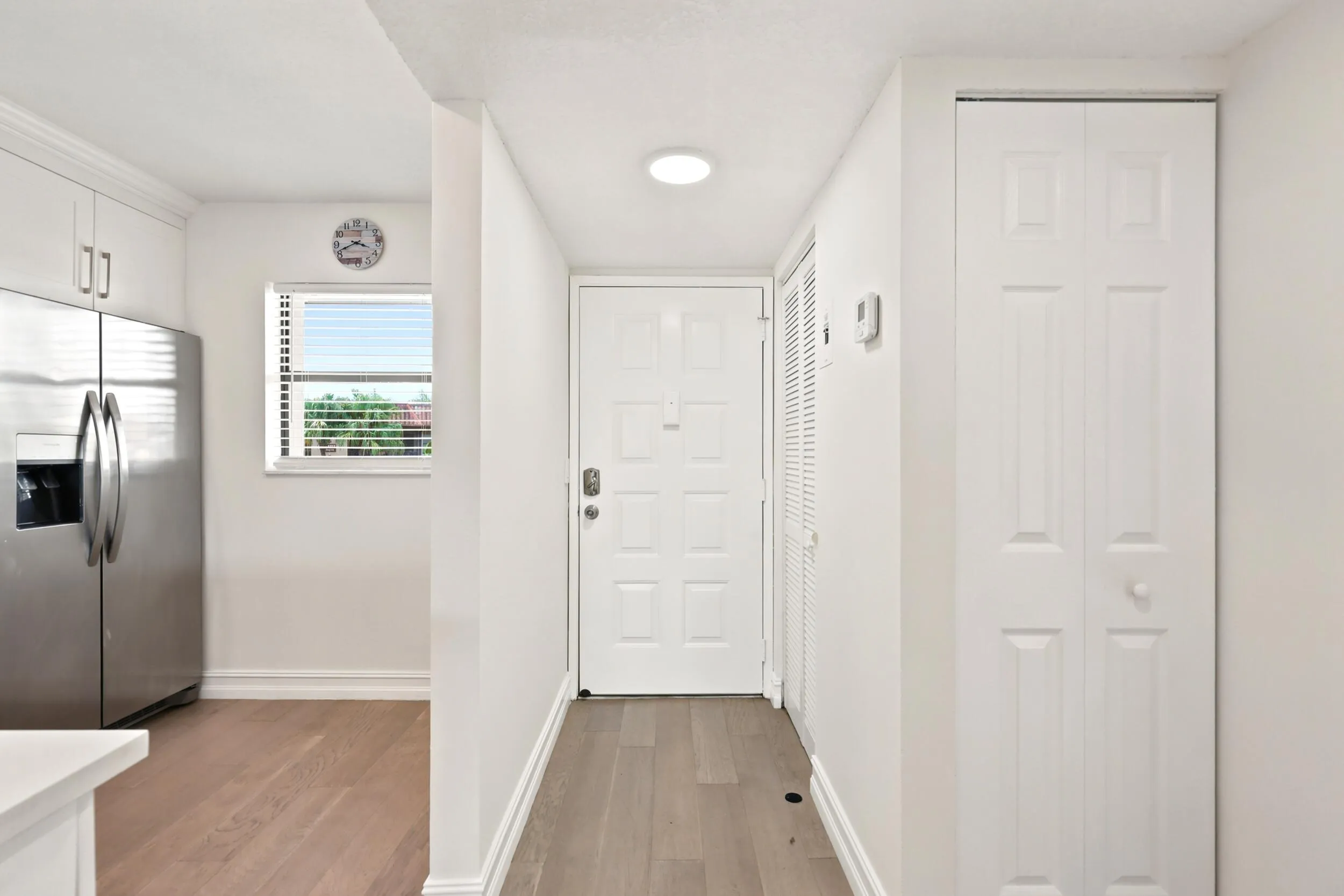 A bright and welcoming entryway sets the tone for the home, featuring updated flooring, neutral finishes, and convenient storage. The functional layout provides a seamless transition into the main living areas while creating an inviting first impression for residents and guests alike.