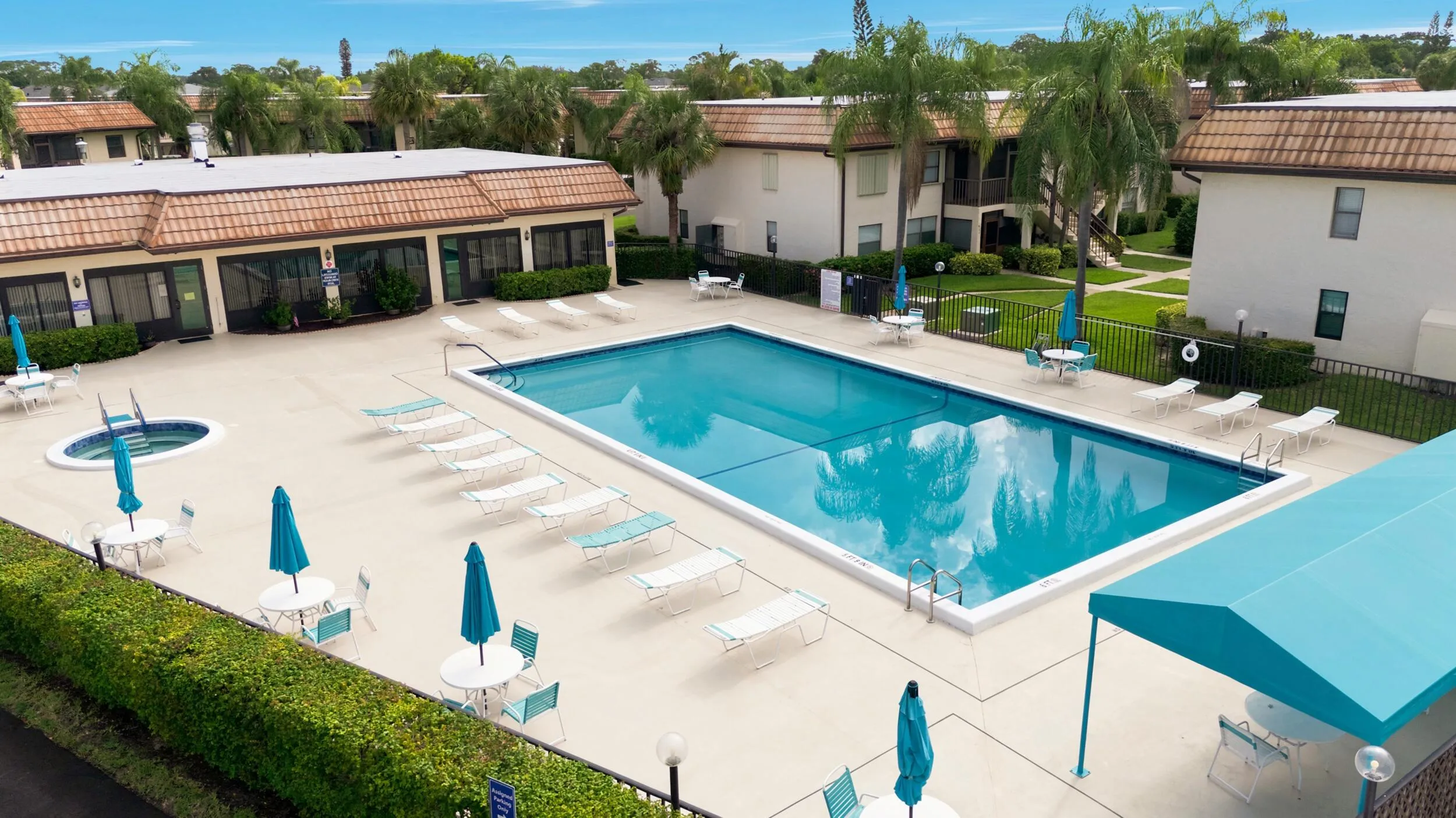 Enjoy resort-style amenities just steps from your door, including a beautifully maintained community pool, relaxing spa, spacious sun deck, and shaded seating areas. Surrounded by tropical landscaping and ample room to unwind, this inviting gathering space offers the perfect setting to soak up the South Florida lifestyle year-round.
