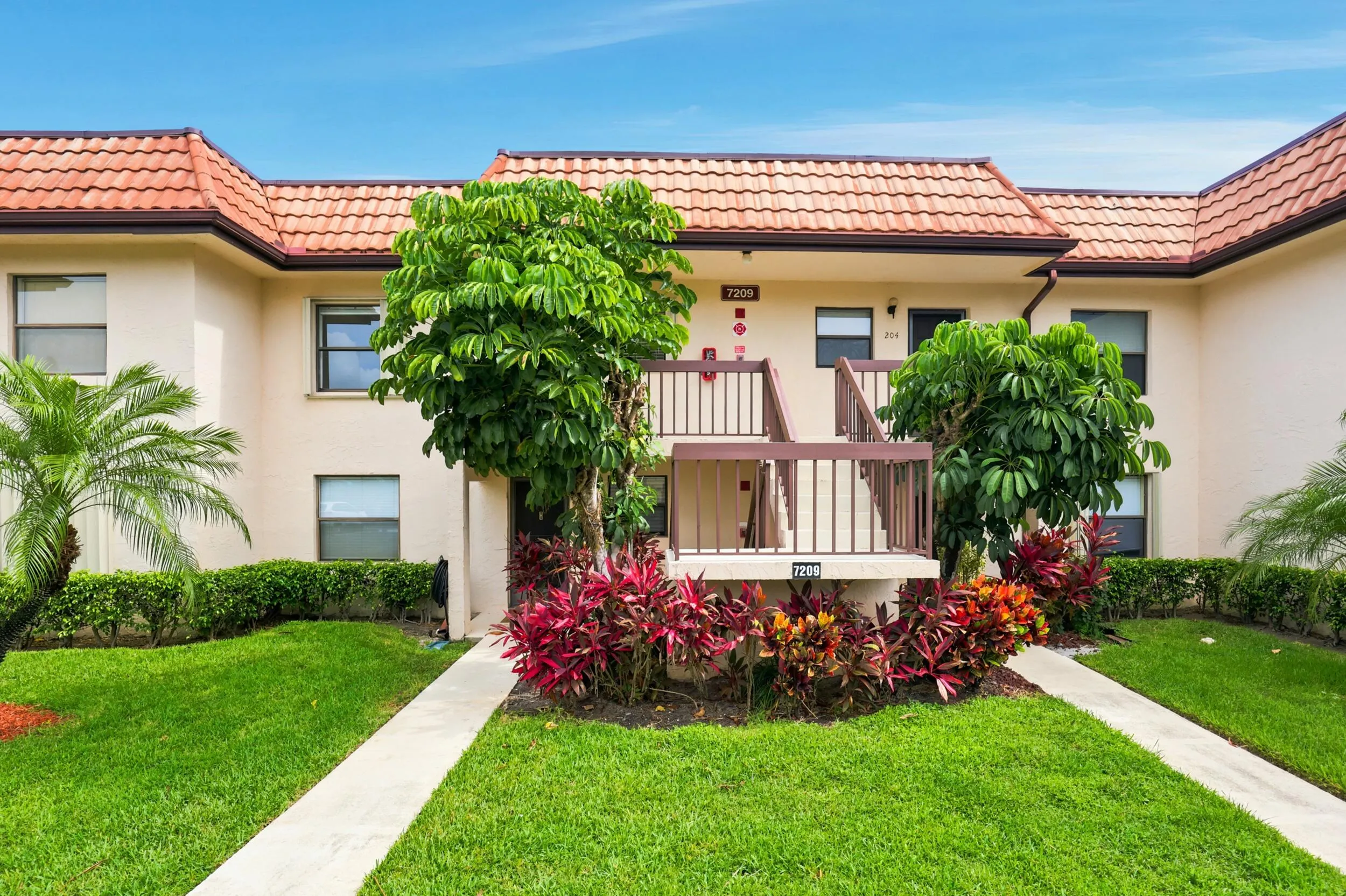 Welcome home to this charming second-floor condominium nestled within the beautifully maintained Golf Colony community. Surrounded by mature tropical landscaping and lush green space, the building offers a welcoming first impression and a peaceful setting to enjoy the South Florida lifestyle. Convenient exterior stair access leads directly to the residence, combining privacy with easy living.