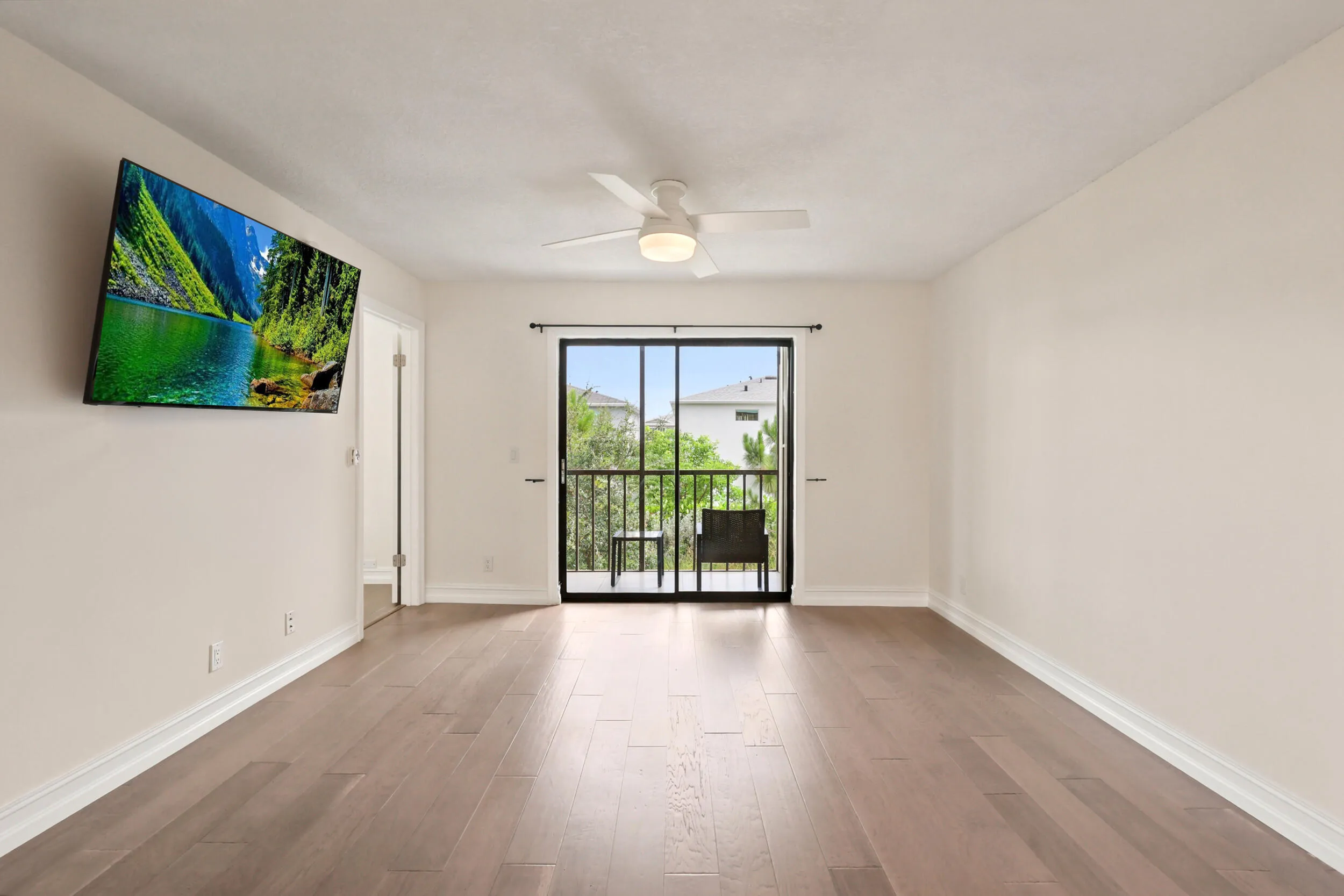 The spacious living area offers an open and versatile layout designed for comfortable everyday living and entertaining. Updated flooring flows throughout the space, while large sliding glass doors fill the room with natural light and provide seamless access to the private screened balcony. The open-concept design connects effortlessly to the kitchen and dining areas, creating a bright and inviting atmosphere throughout the home.