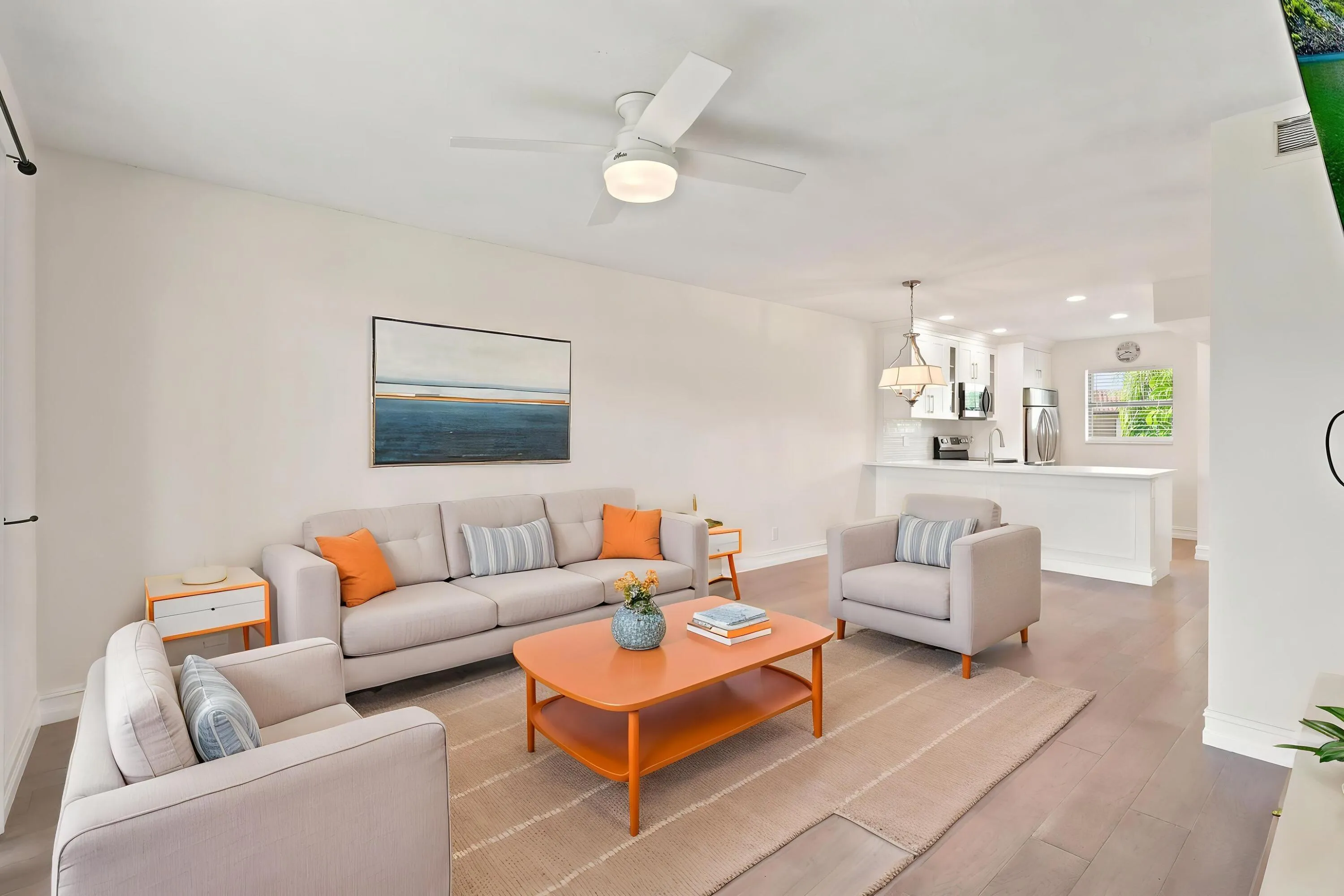 The spacious living area offers an open and versatile layout designed for comfortable everyday living and entertaining. Updated flooring flows throughout the space, while large sliding glass doors fill the room with natural light and provide seamless access to the private screened balcony. The open-concept design connects effortlessly to the kitchen and dining areas, creating a bright and inviting atmosphere throughout the home.