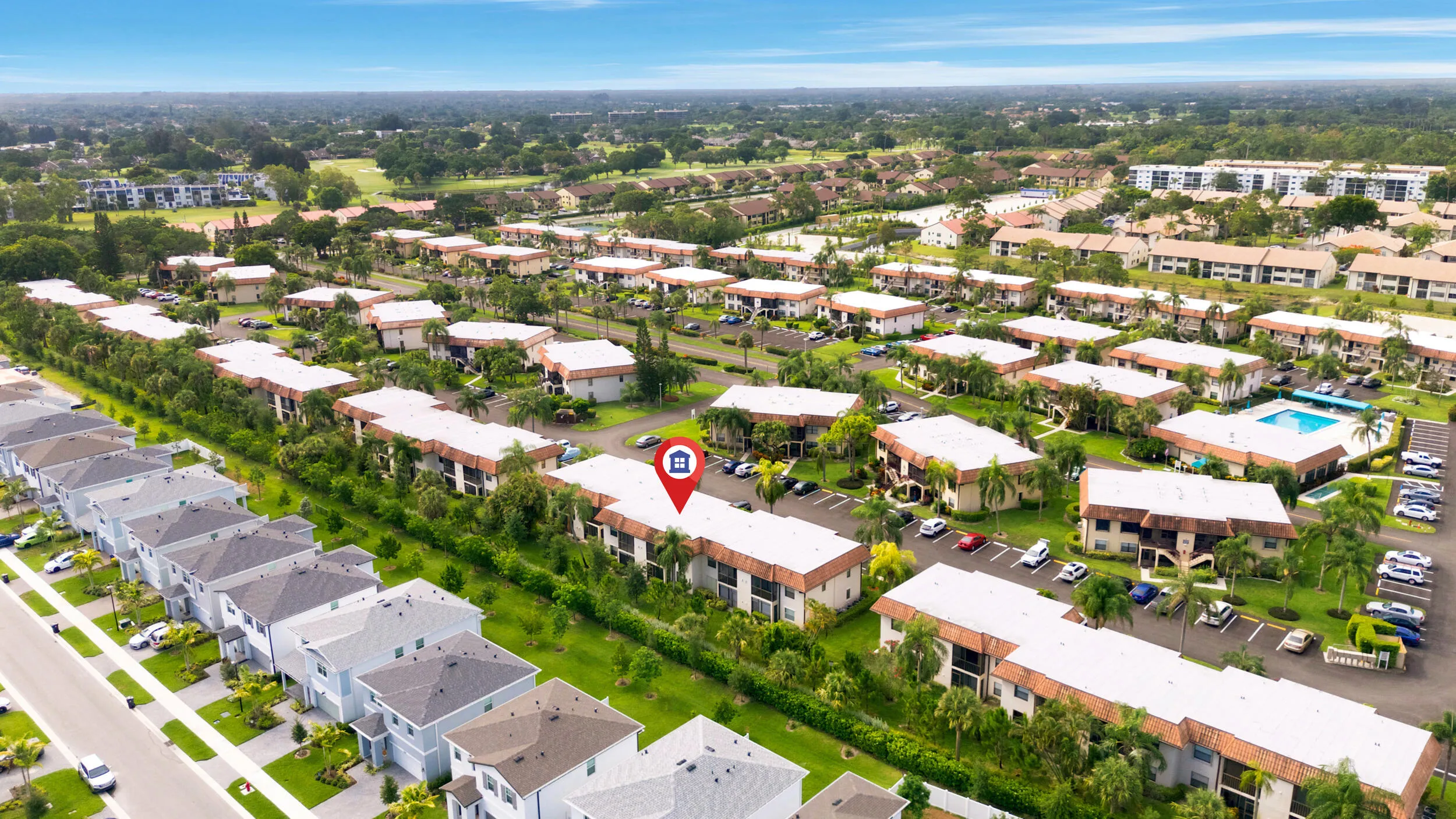Enjoy a bird’s-eye perspective of this well-maintained community, showcasing the building's convenient location, abundant parking, mature tropical landscaping, and beautifully maintained grounds. Positioned within a peaceful residential setting, the property offers easy access to nearby shopping, dining, golf courses, parks, and major commuter routes while providing a tranquil place to call home.
