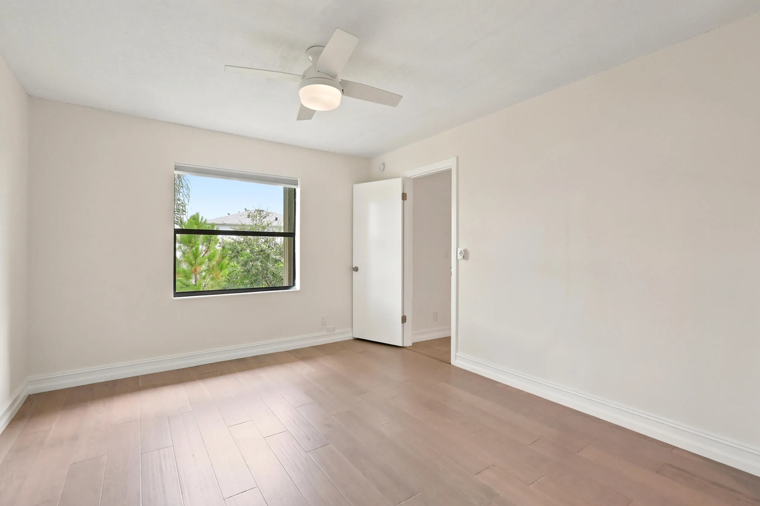 The spacious primary suite offers a peaceful retreat with updated flooring, abundant natural light, and a clean, modern aesthetic. A generous walk-in closet provides excellent storage, while the private ensuite bath adds convenience and functionality. The comfortable layout creates the perfect space to relax and unwind at the end of the day.