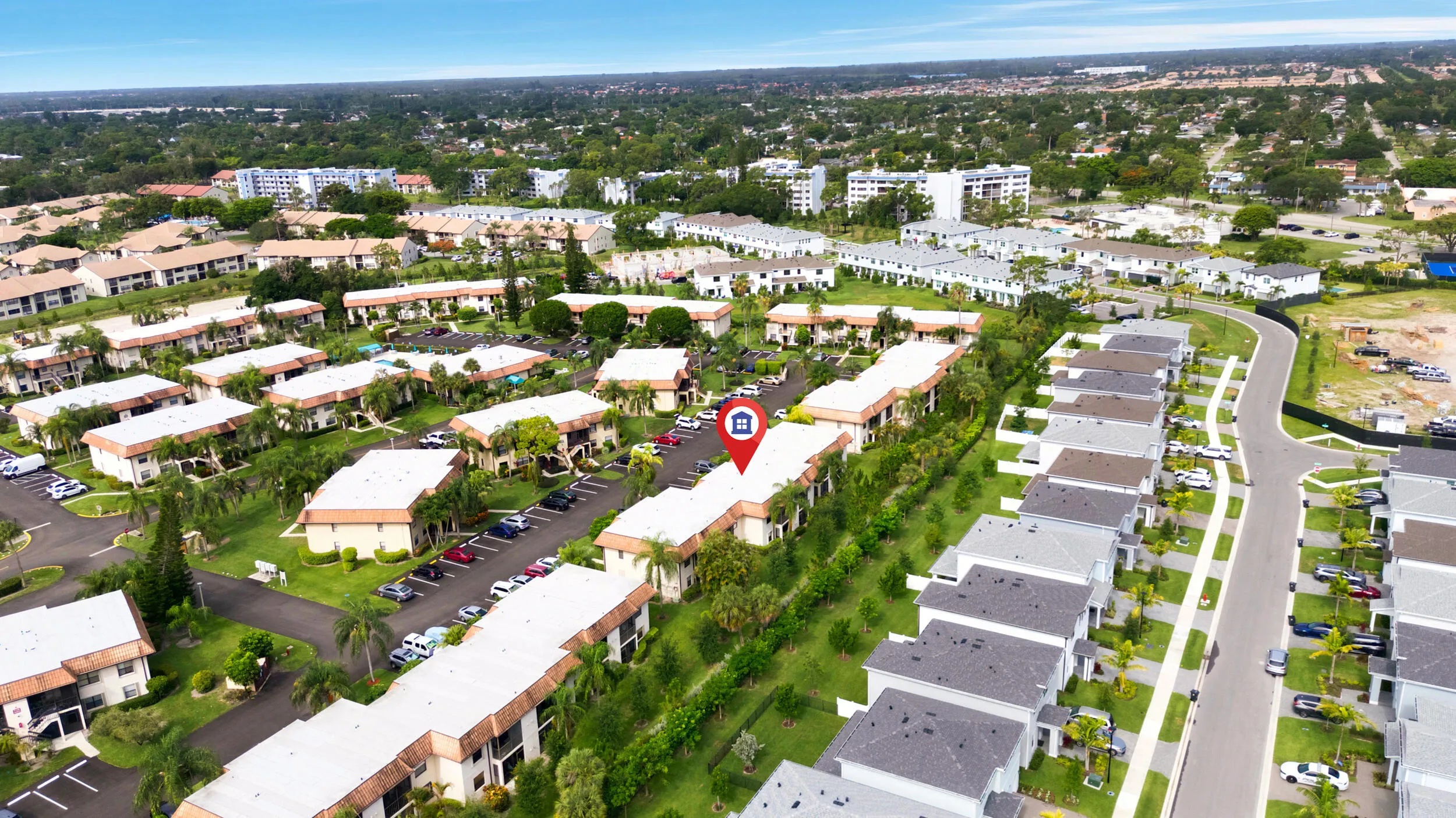 Enjoy a bird’s-eye perspective of this well-maintained community, showcasing the building's convenient location, abundant parking, mature tropical landscaping, and beautifully maintained grounds. Positioned within a peaceful residential setting, the property offers easy access to nearby shopping, dining, golf courses, parks, and major commuter routes while providing a tranquil place to call home.